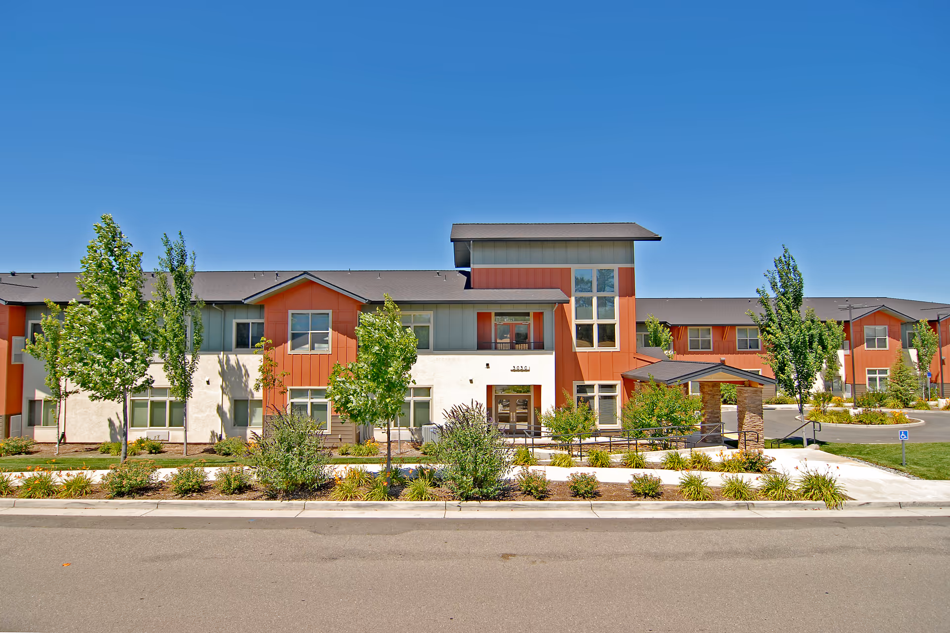 Exterior view of The Vistas Assisted Living and Memory Care, a modern building with landscaping.