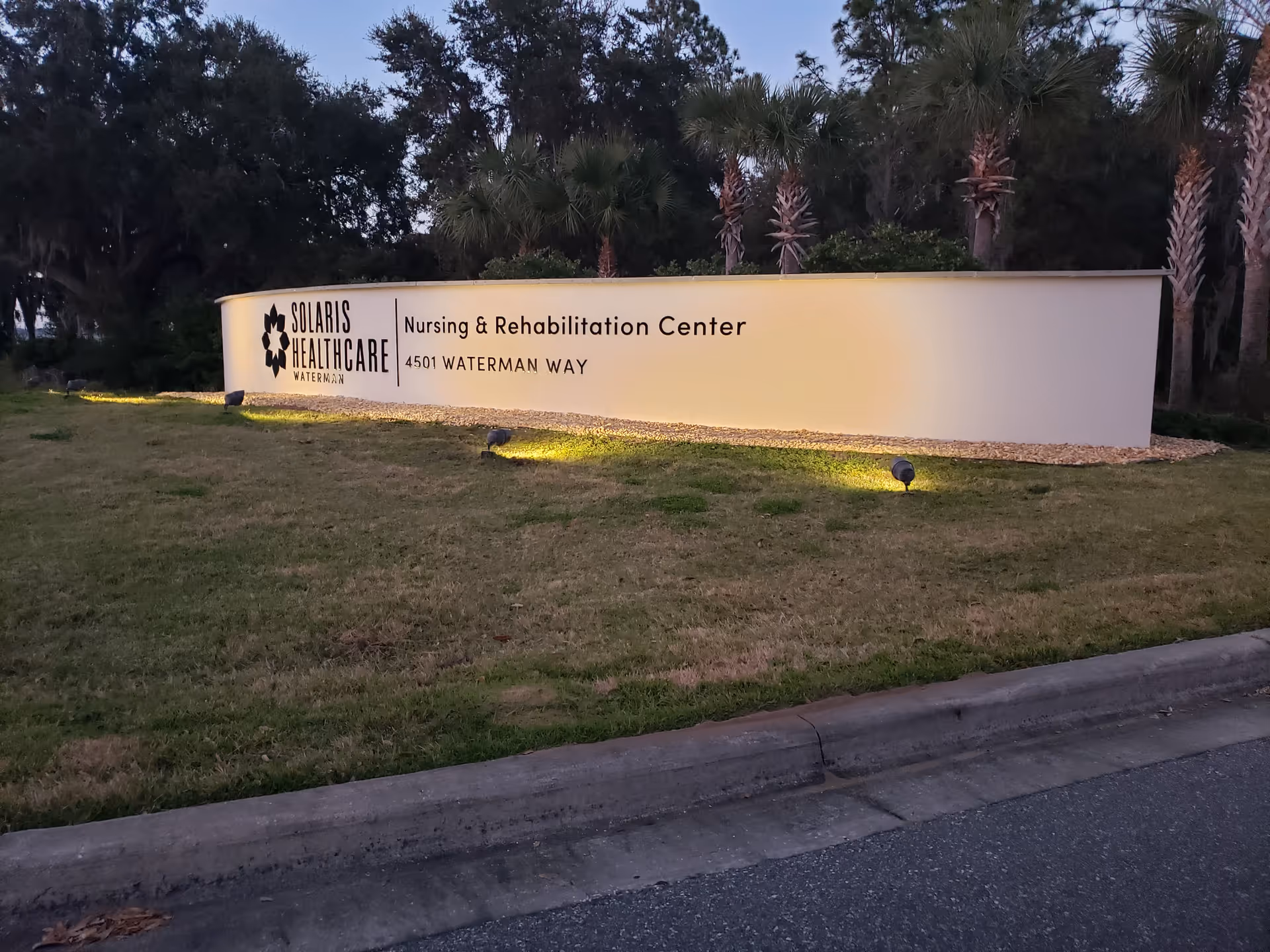 Exterior sign for Solaris Healthcare Waterman Nursing & Rehabilitation Center along a manicured lawn.