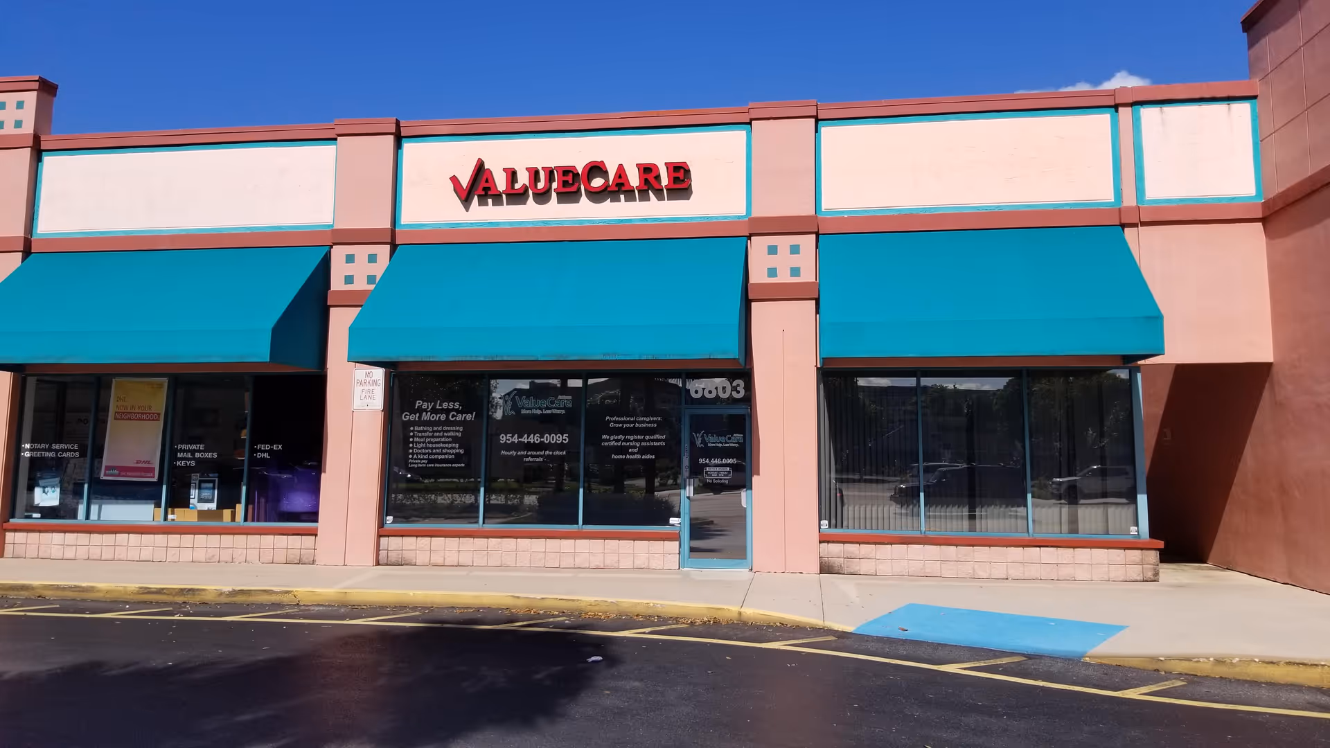 ValueCare storefront with teal awnings and large windows on a pastel building.