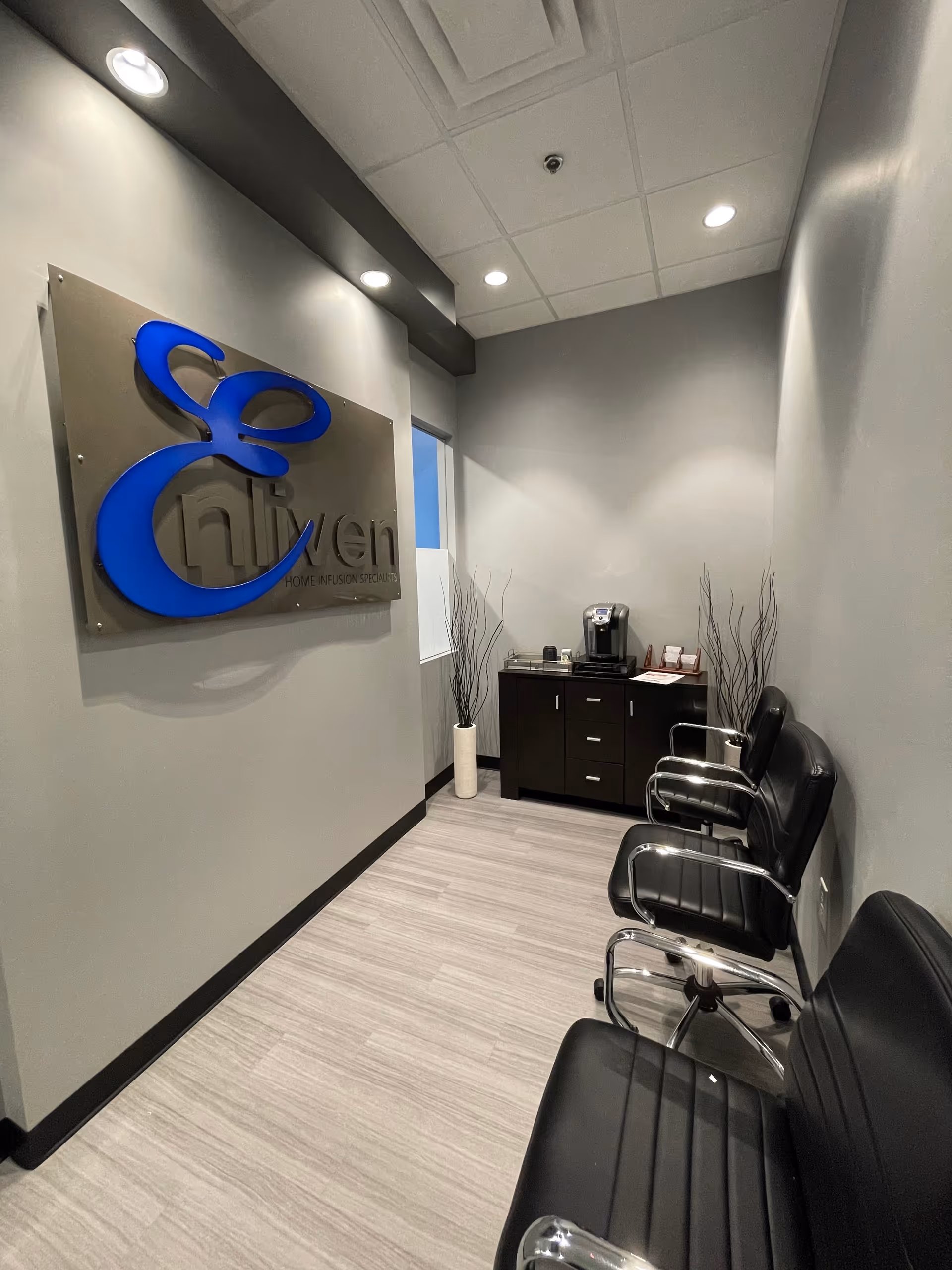 Reception area with Enliven sign, waiting chairs, and a coffee station.