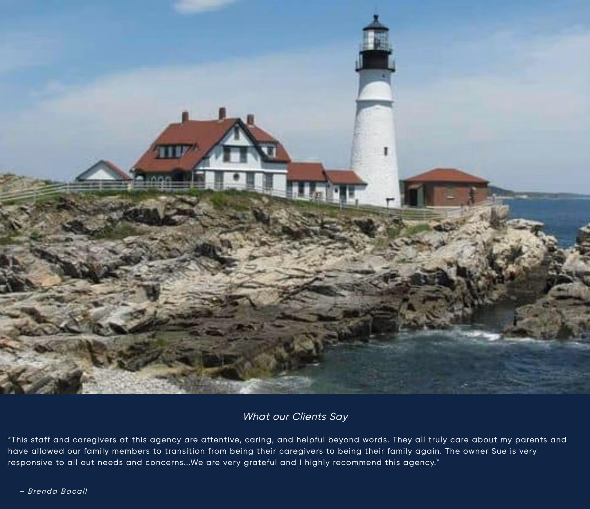 Lighthouse and white buildings sit on rugged coastline overlooking the ocean.