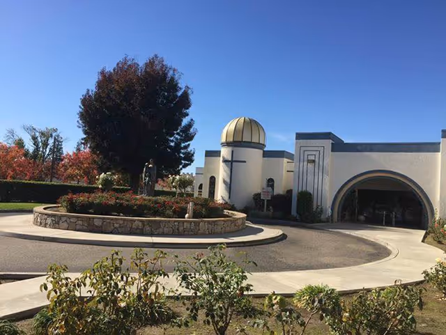 Exterior view of St. Thomas Retirement Center with circular driveway and landscaped garden.