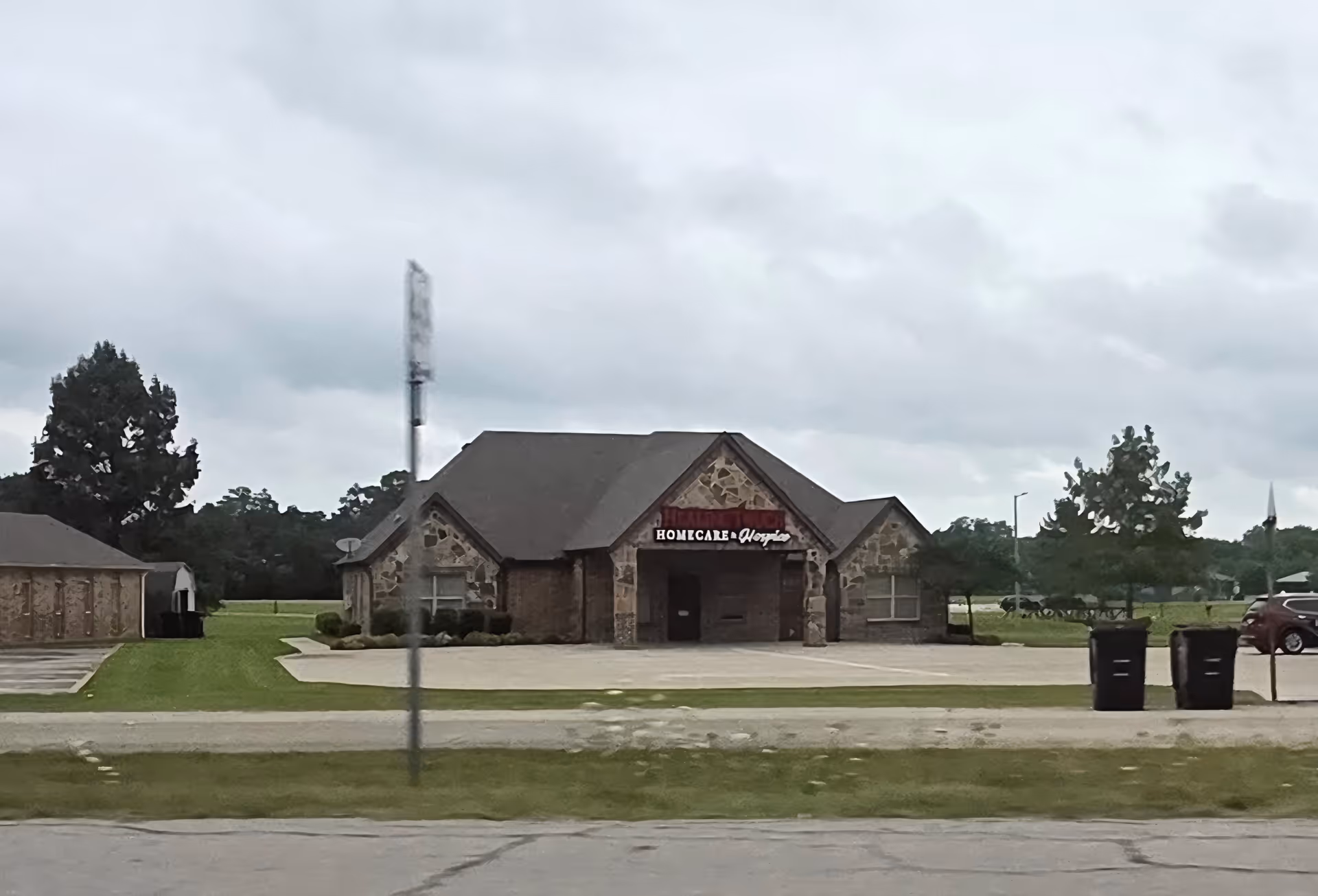 Exterior view of Healing Touch Homecare and Hospice building with stone facade and sign.