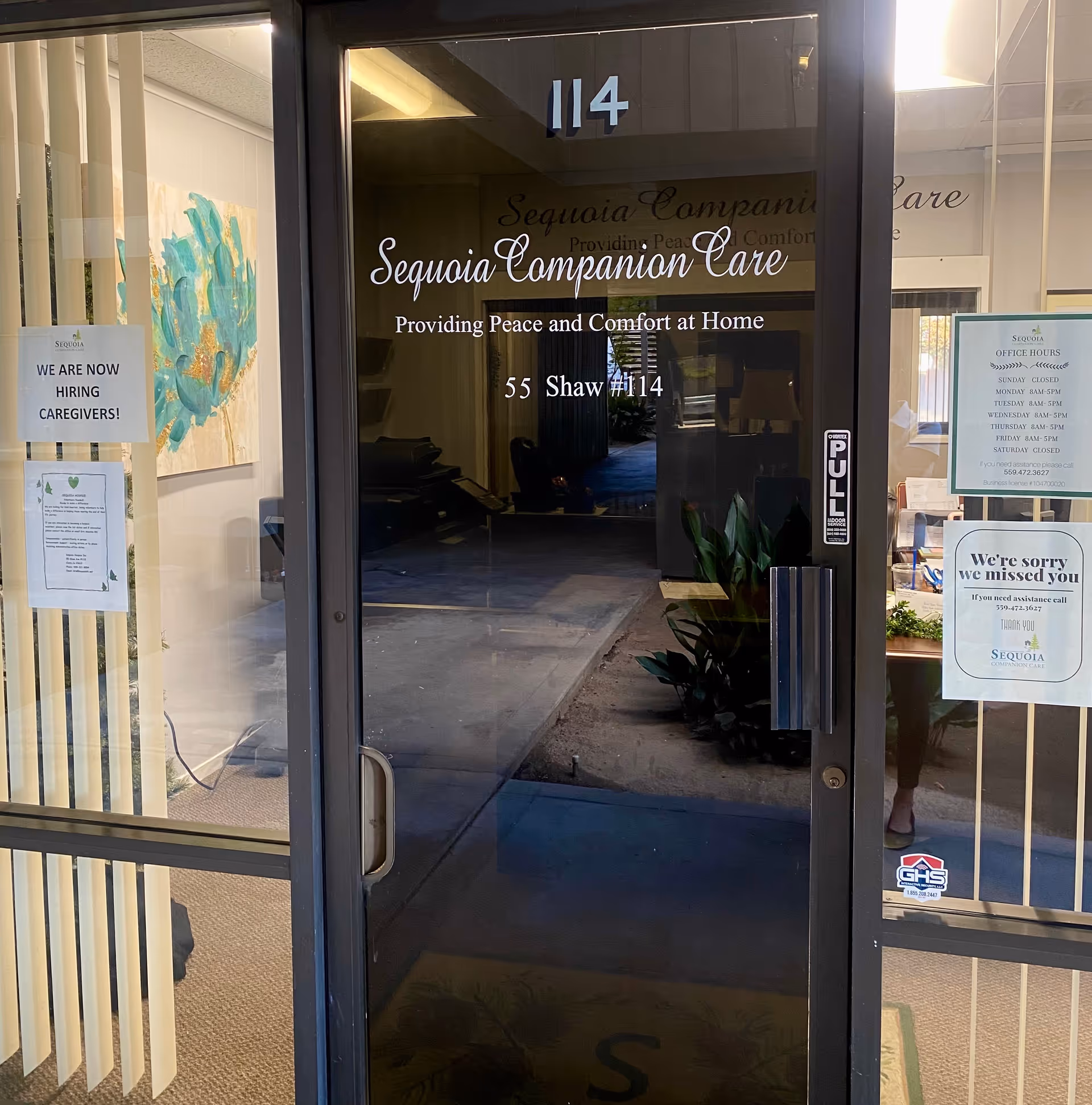 Glass entrance to Sequoia Companion Care; hiring posters, visible lobby.