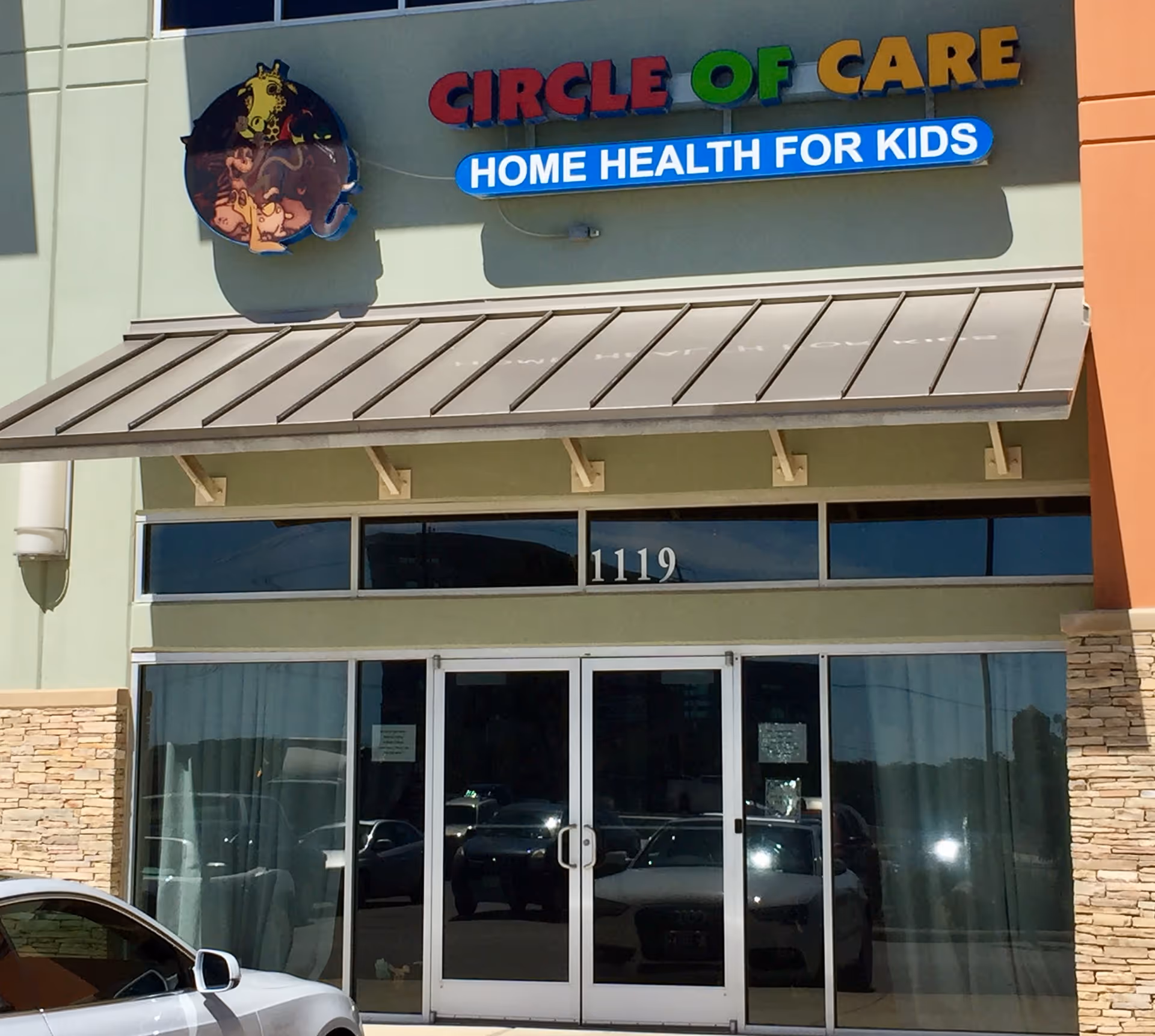 Front view of Circle of Care corporate office with glass doors and sign
