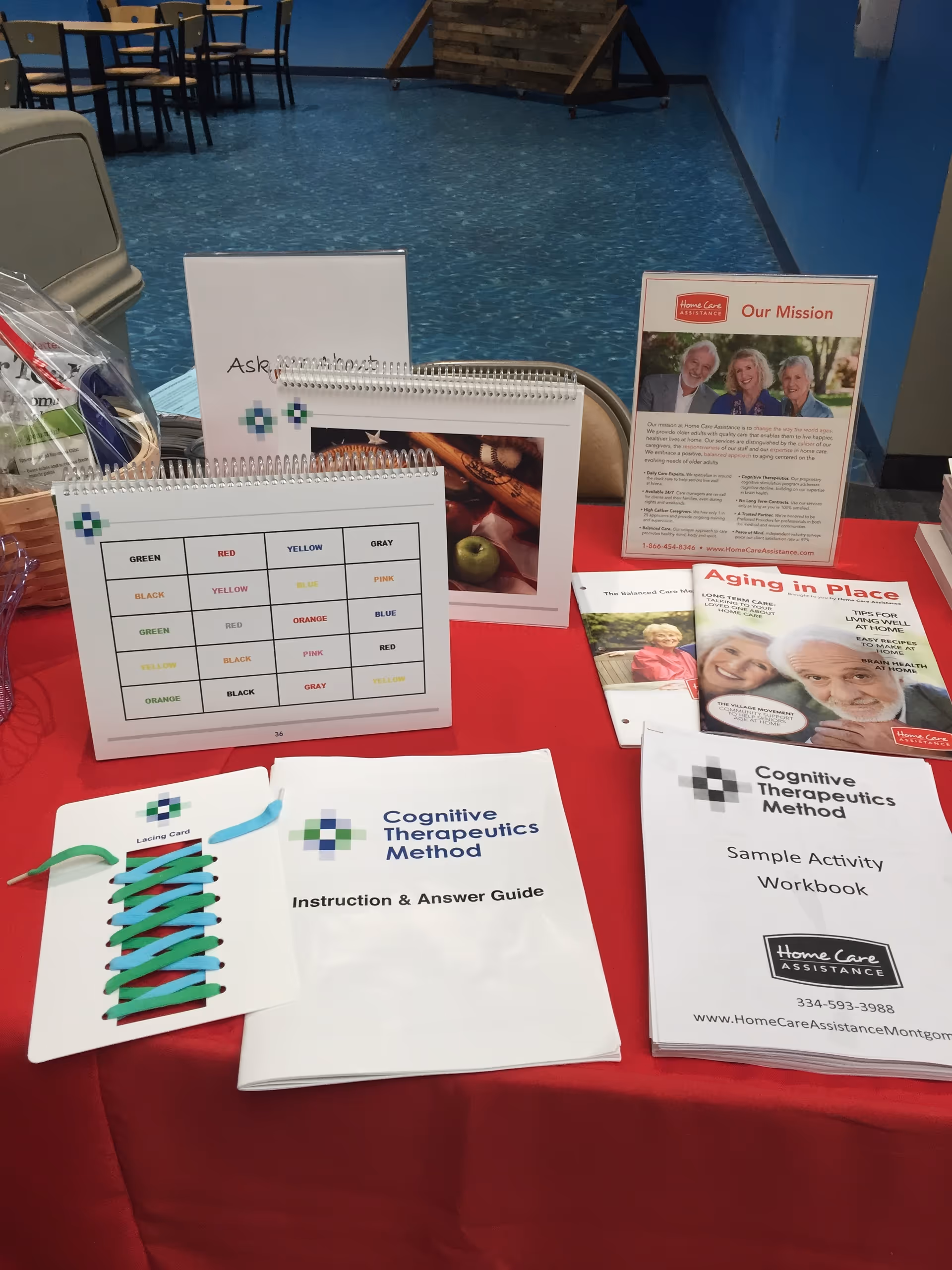 Table with brochures and guides for cognitive therapy in a senior care facility lobby.