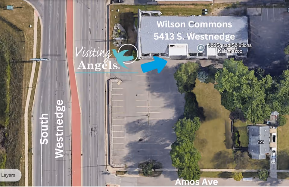 Aerial view of Visiting Angels facility in Plainwell with parking lot and street.