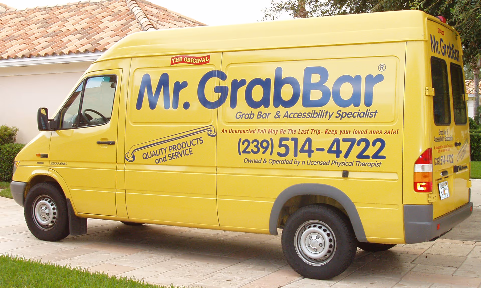 Bright yellow Mr. GrabBar van with large blue logo parked on a driveway.