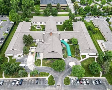 Aerial view of The Village of Westerville senior living campus with interconnected buildings and parking.