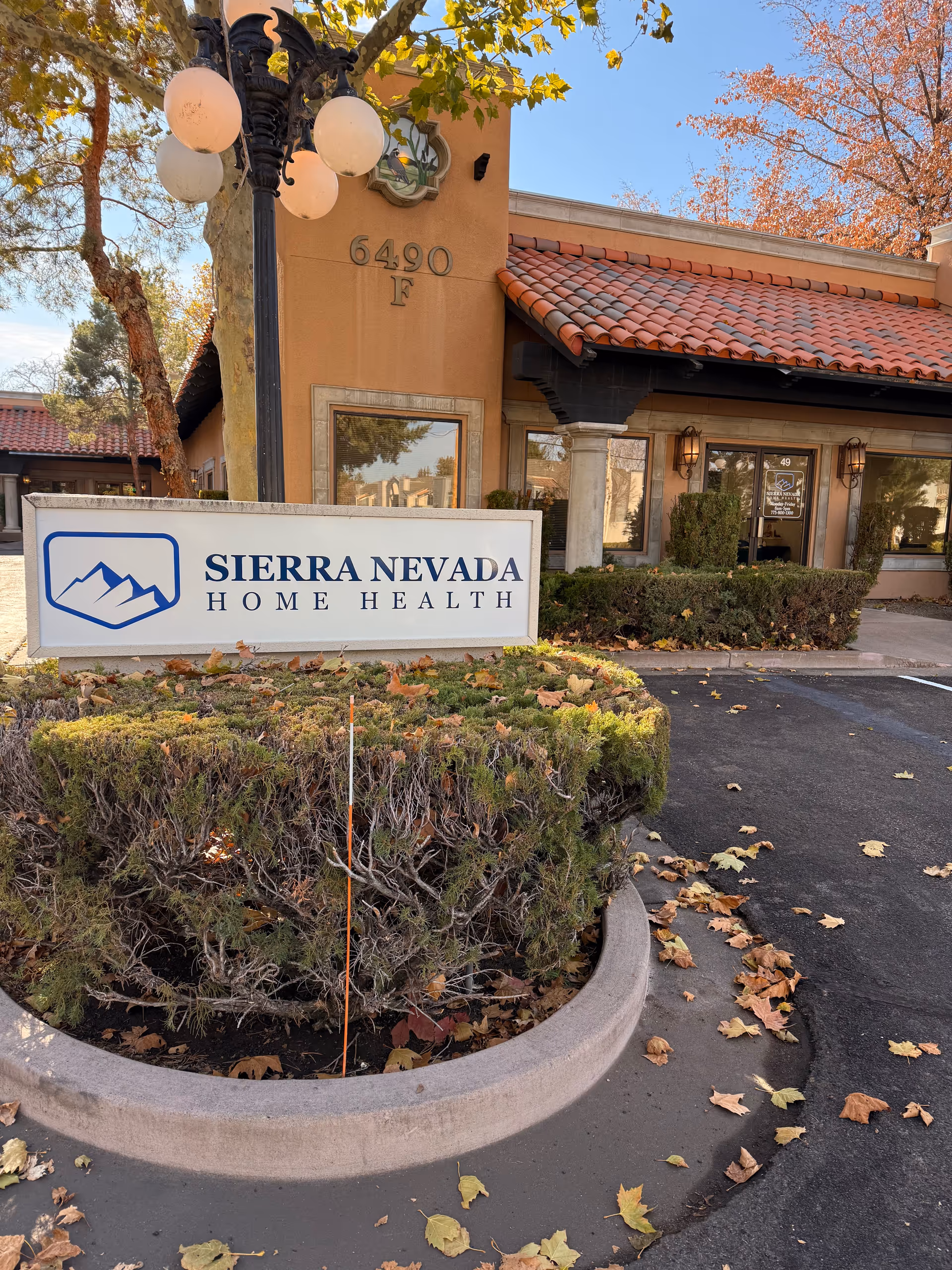 Front view of Sierra Nevada Home Health building with sign and landscaping.