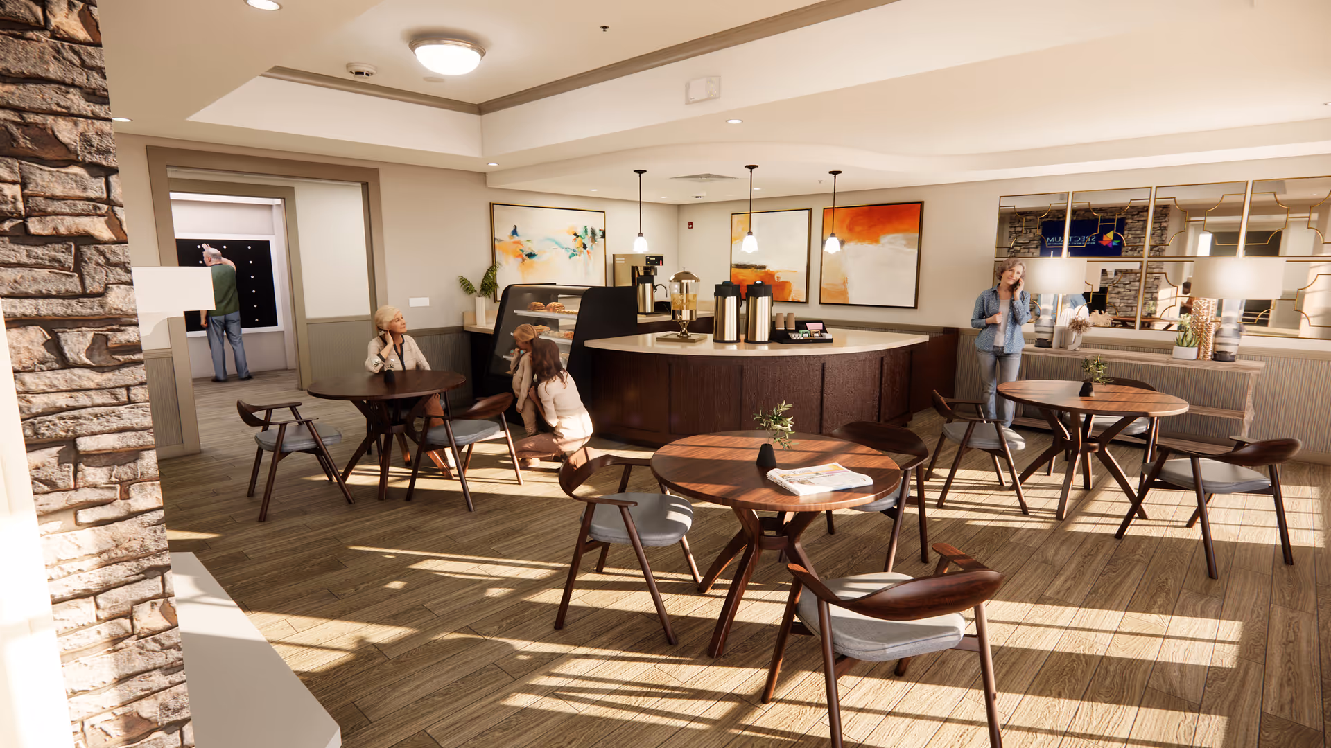 A bright and spacious common area in a senior living facility with wooden floors and modern furniture. There are round wooden tables with chairs around them, a coffee and snack counter with three pendant lights hanging above, and abstract paintings on the wall. Several seniors are seated or standing, engaging in conversation or activities. Large windows allow natural light to fill the room.