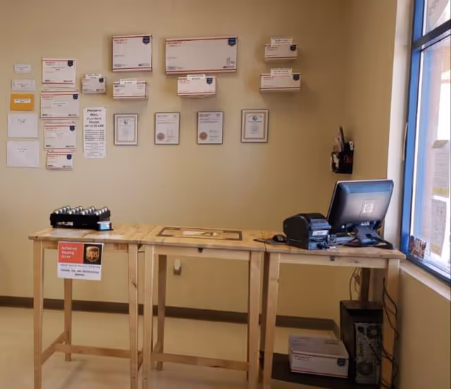 Reception area with a wooden front desk, computer, and wall-mounted certificates inside the facility.
