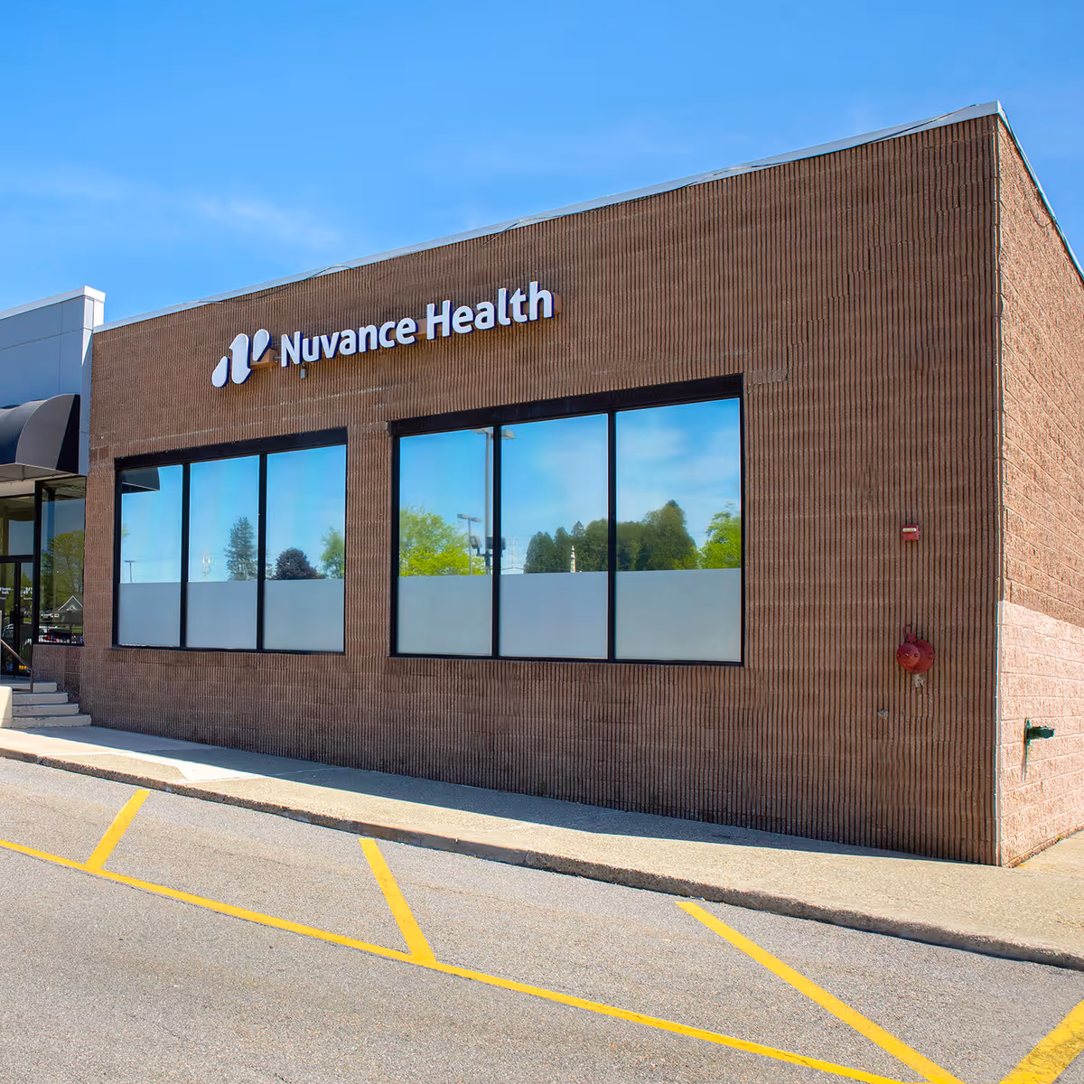 Brick exterior building with Nuvance Health sign and large front windows.