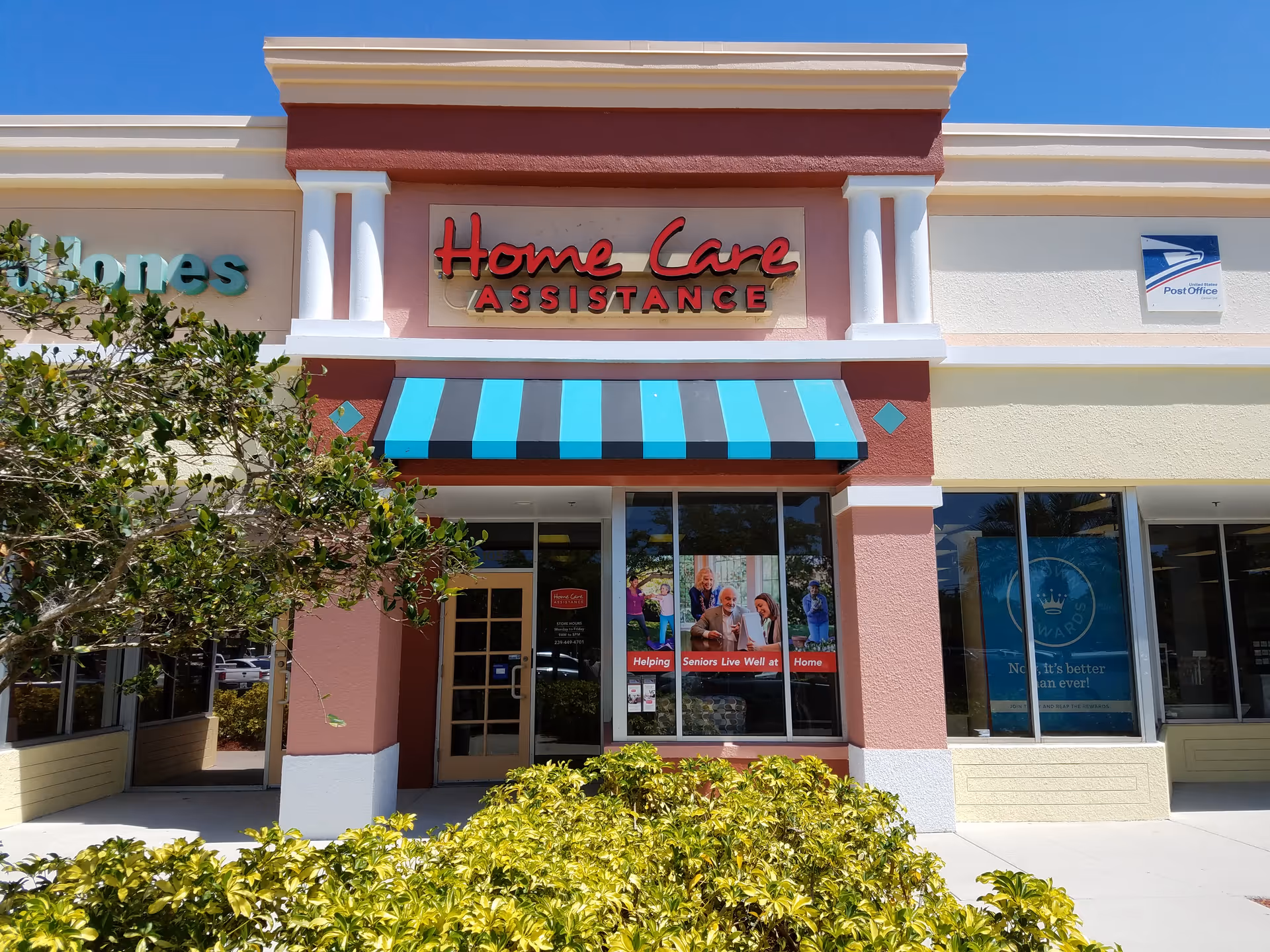 Storefront of a senior care facility with Home Care Assistance signage and blue awning.