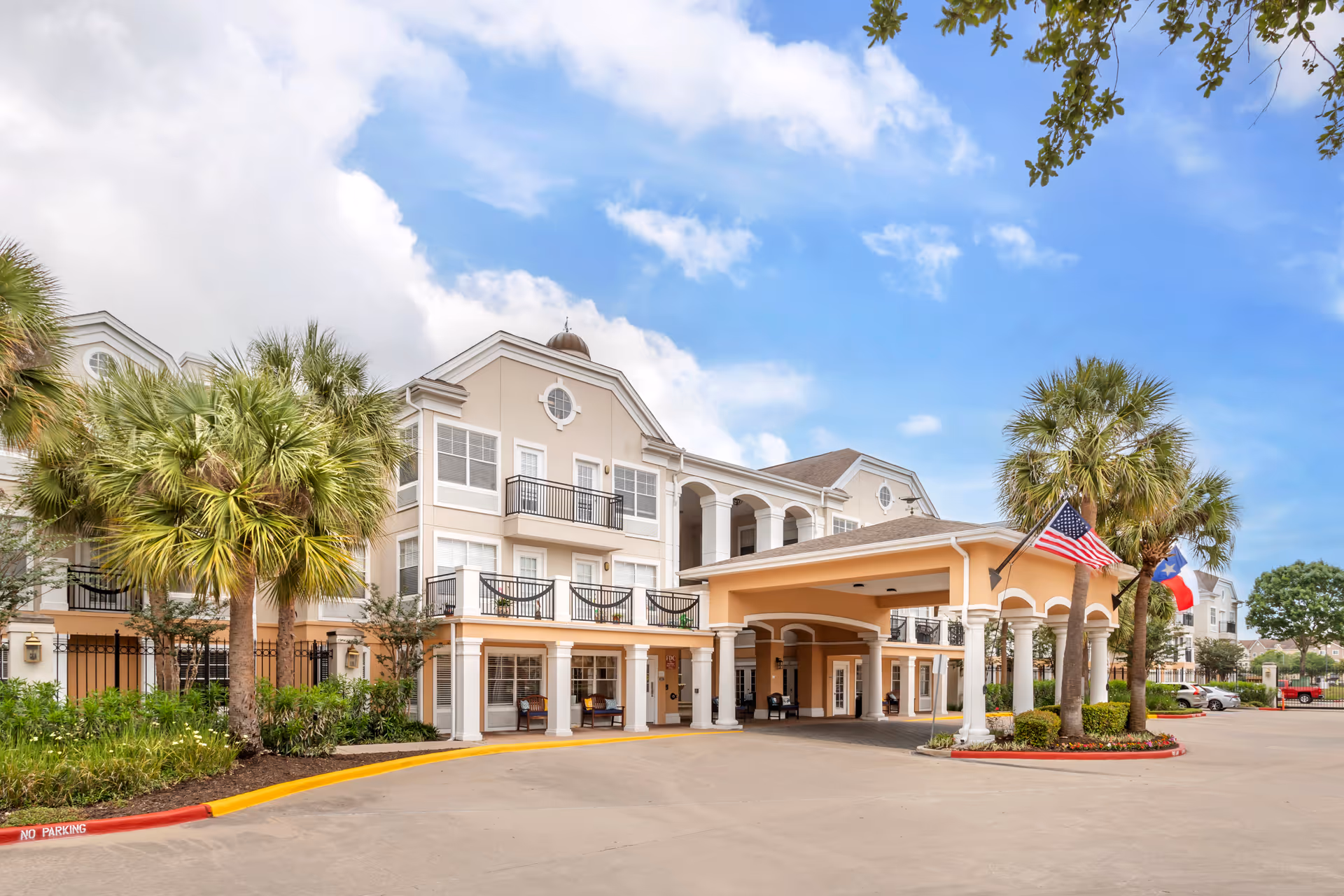 Front exterior of Brookdale Clarksville senior living facility with palm trees and porte-cochère.
