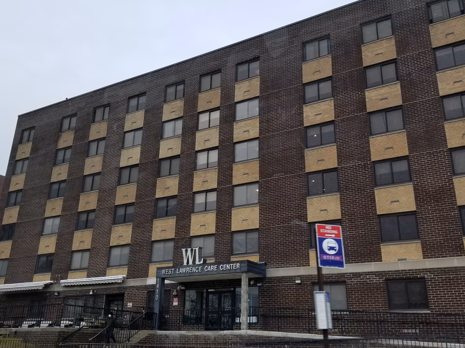 Brick, multi-story building with West Lawrence Care Center sign at the entrance.