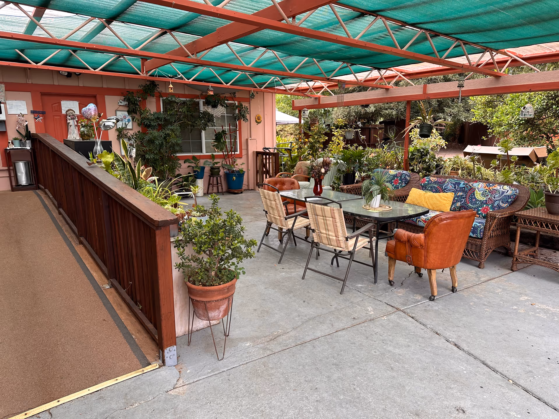 Outdoor patio seating area at Angel's Place in Mosswood Place with plants and furniture.