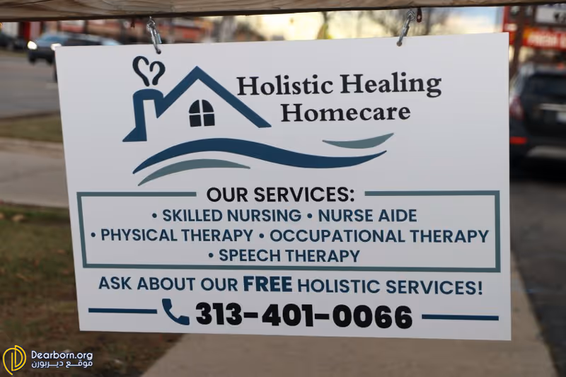 An outdoor sign for Holistic Healing Homecare listing services and a contact number.