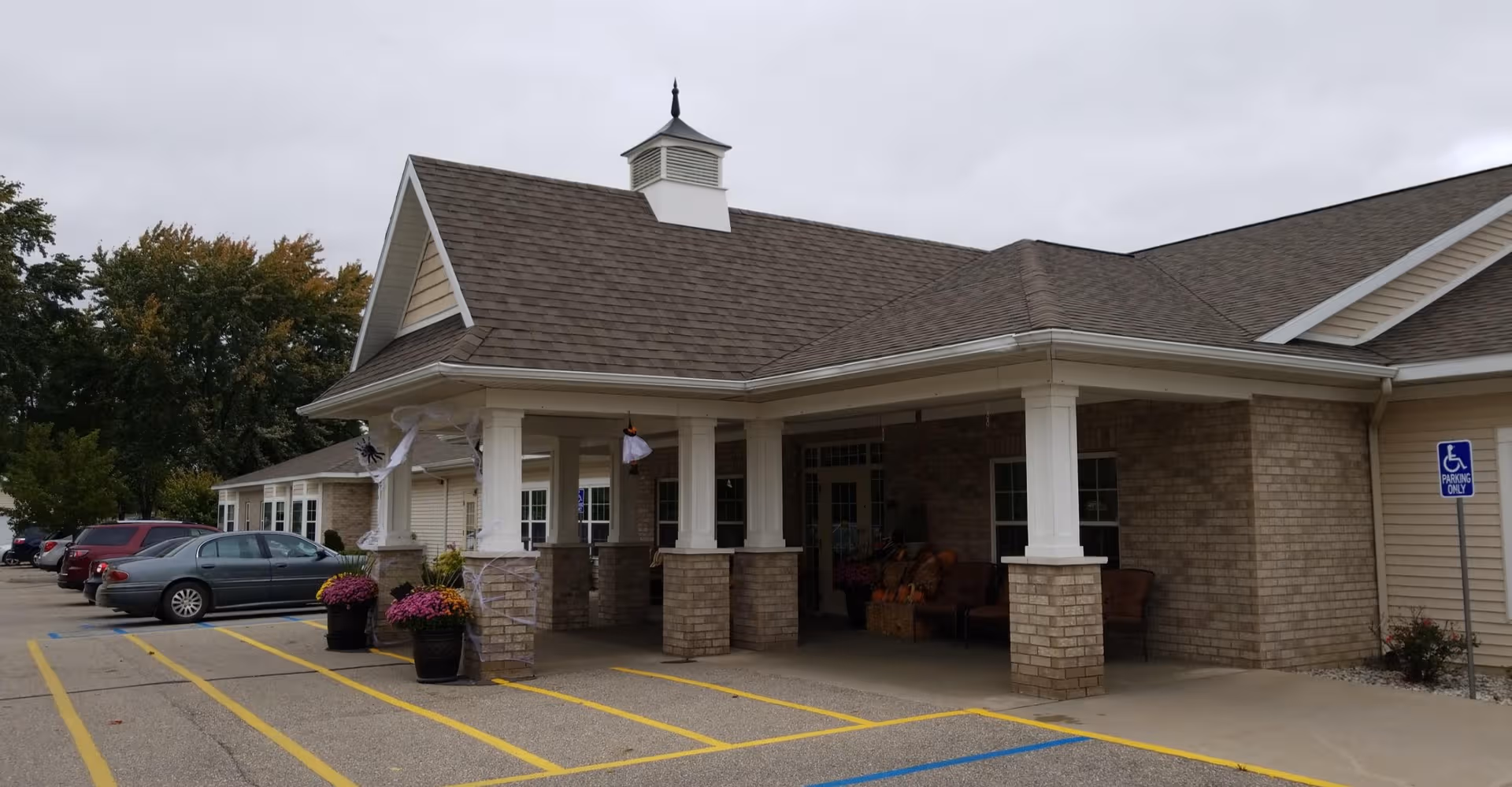 Arbor Grove Assisted Living & Memory Care entrance with covered porch and parking.