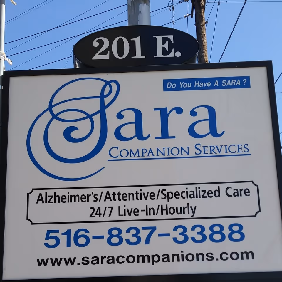 Outdoor sign advertising Sara Companion Services with Alzheimer's care and contact info.