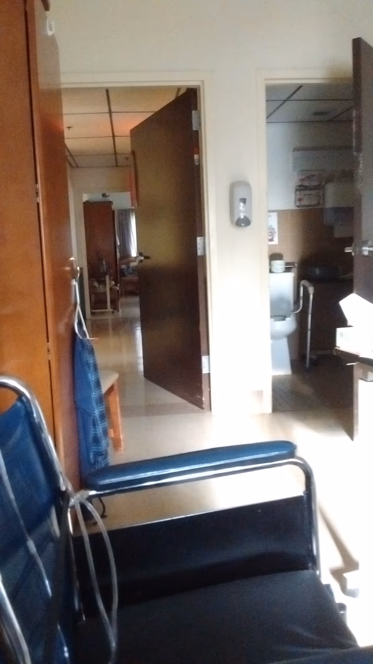 Interior hallway at Meadowbrook at Oconto Falls with a blue chair.