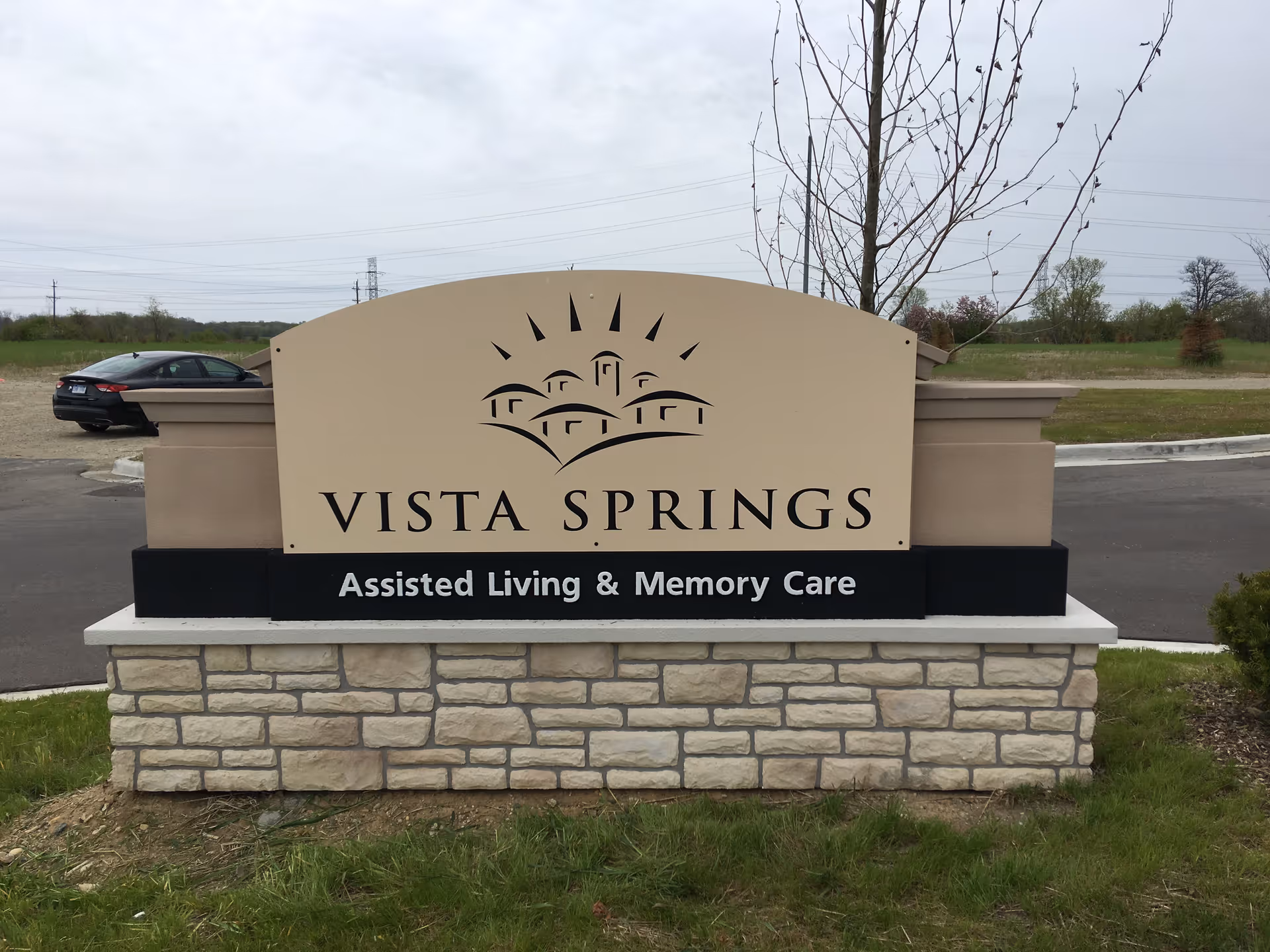 Vista Springs sign on stone base reads 'Assisted Living & Memory Care'.