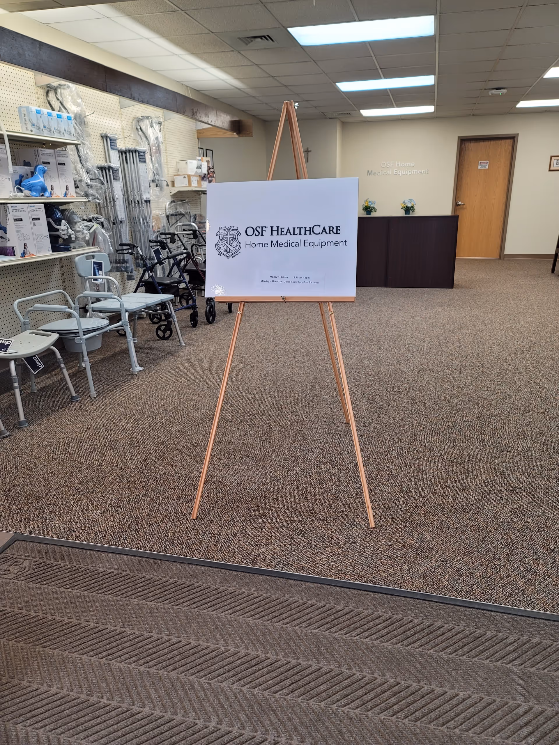 Interior of OSF HealthCare Home Medical Equipment showroom with an easel sign and mobility aids