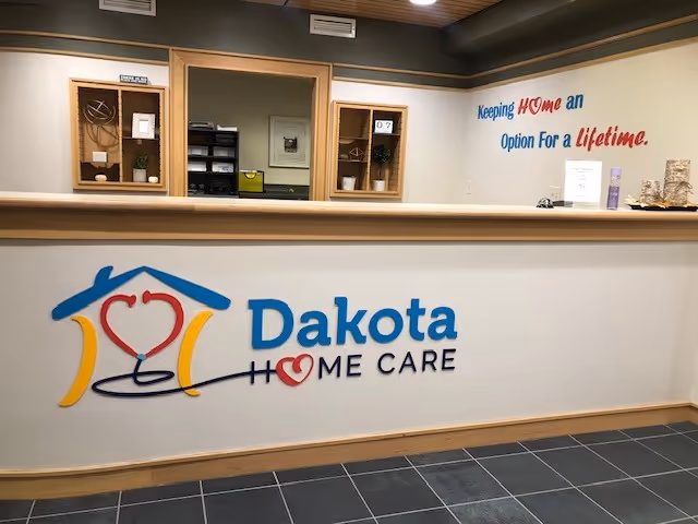 Reception desk featuring Dakota Home Care logo in a facility lobby.