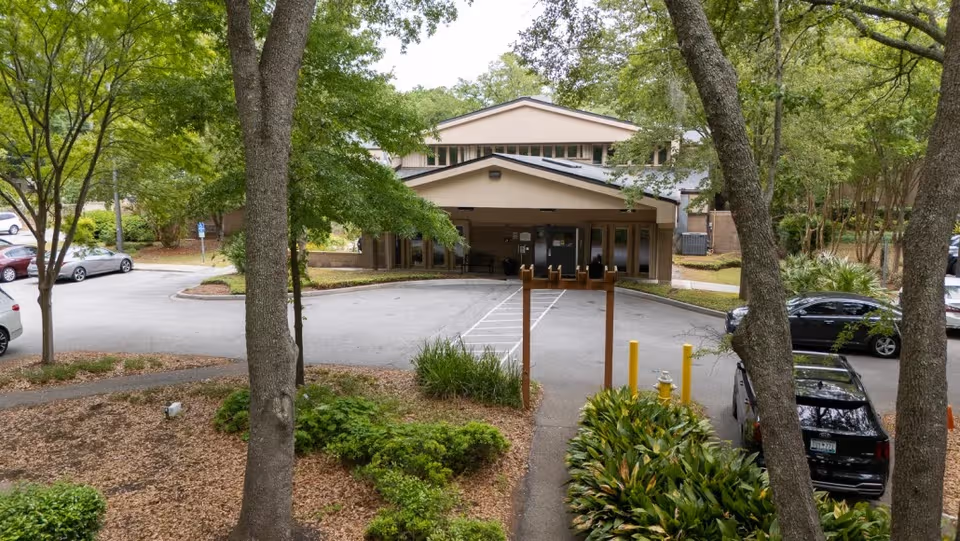 Exterior view of Ashley River Healthcare with a covered entrance and greenery.