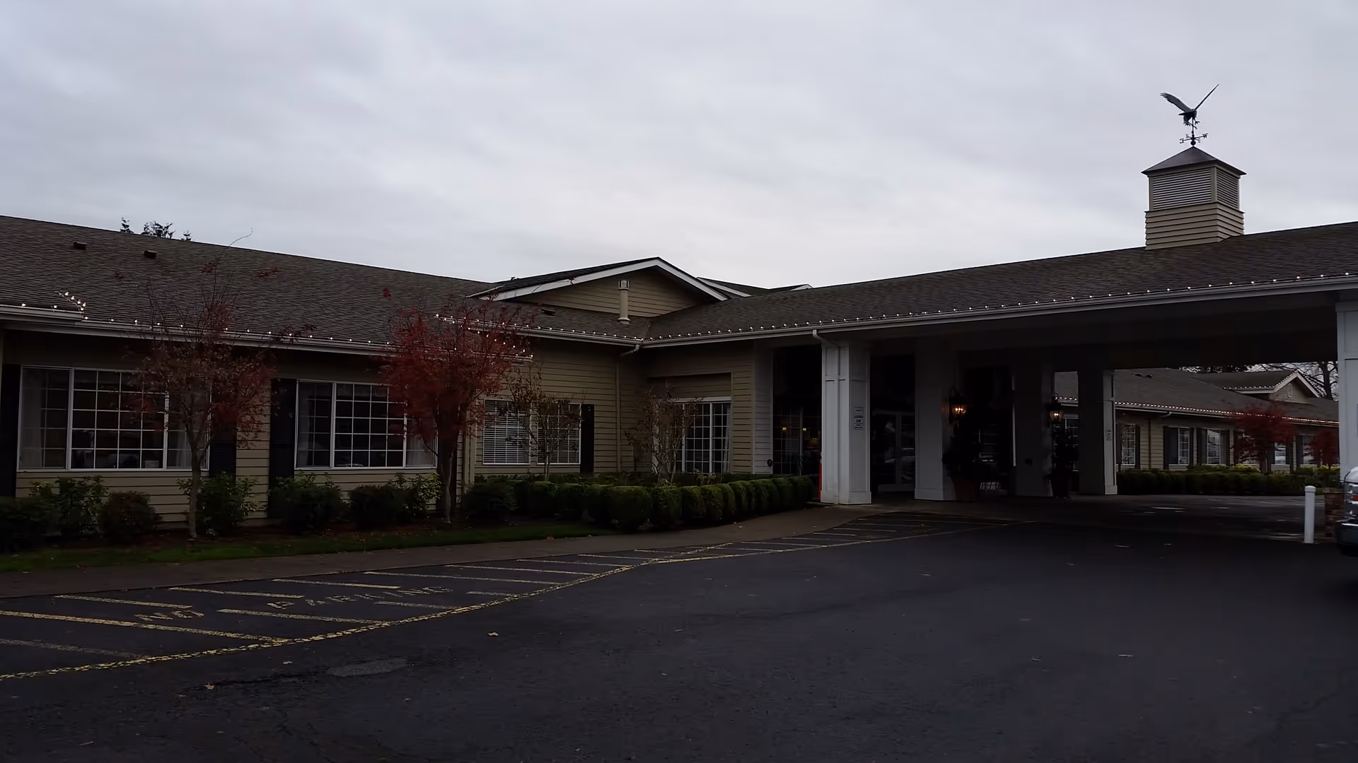 Canterbury Inn Assisted Living Community building exterior with a covered entrance and parking lot.
