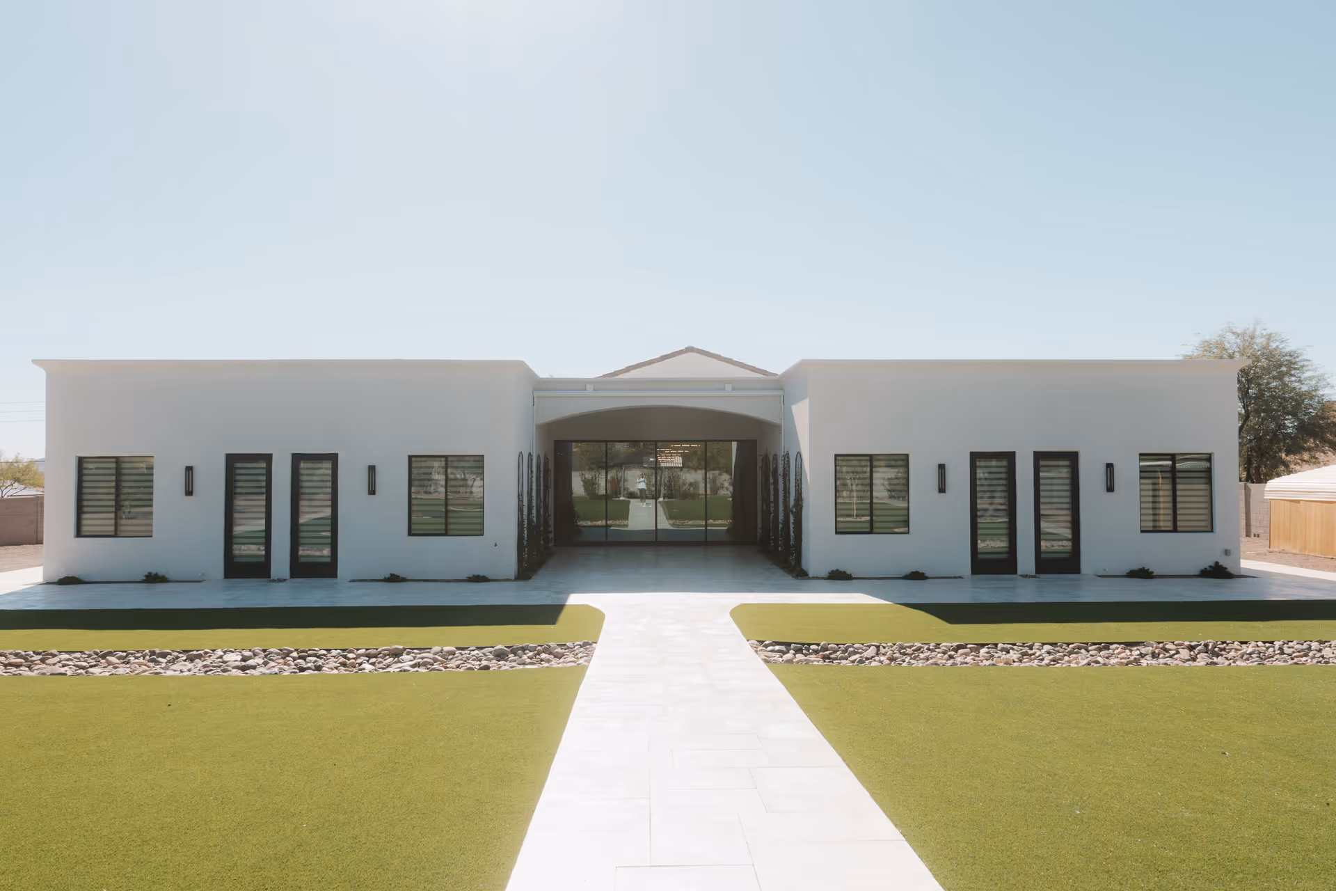 Front view of Deer Valley Care Home: white building with central entry and manicured lawn.
