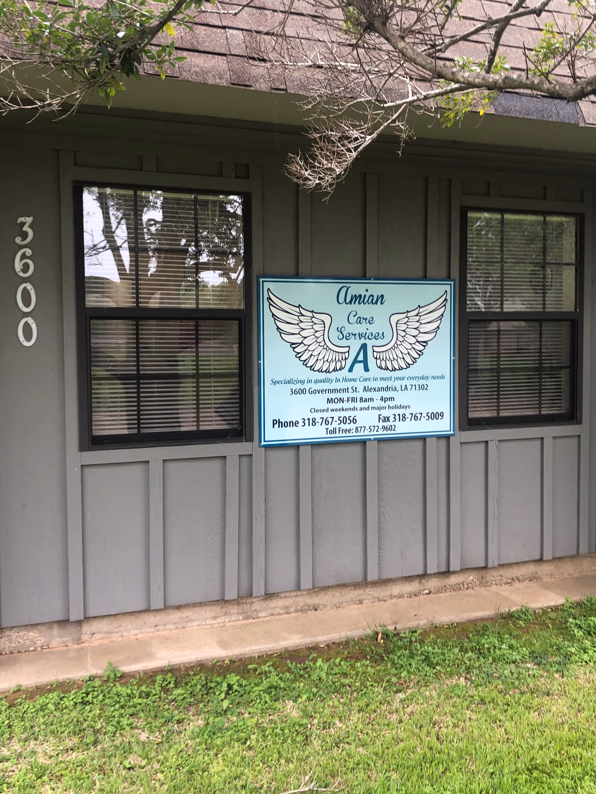 Gray exterior of a facility with a sign reading Amian Care Services and wings