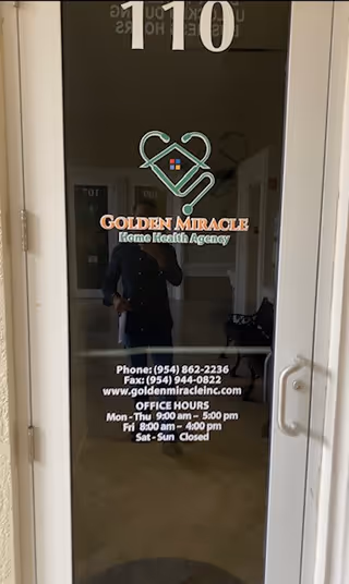 Glass door displays Golden Miracle Home Health Agency logo, phone numbers, office hours, and reflection.