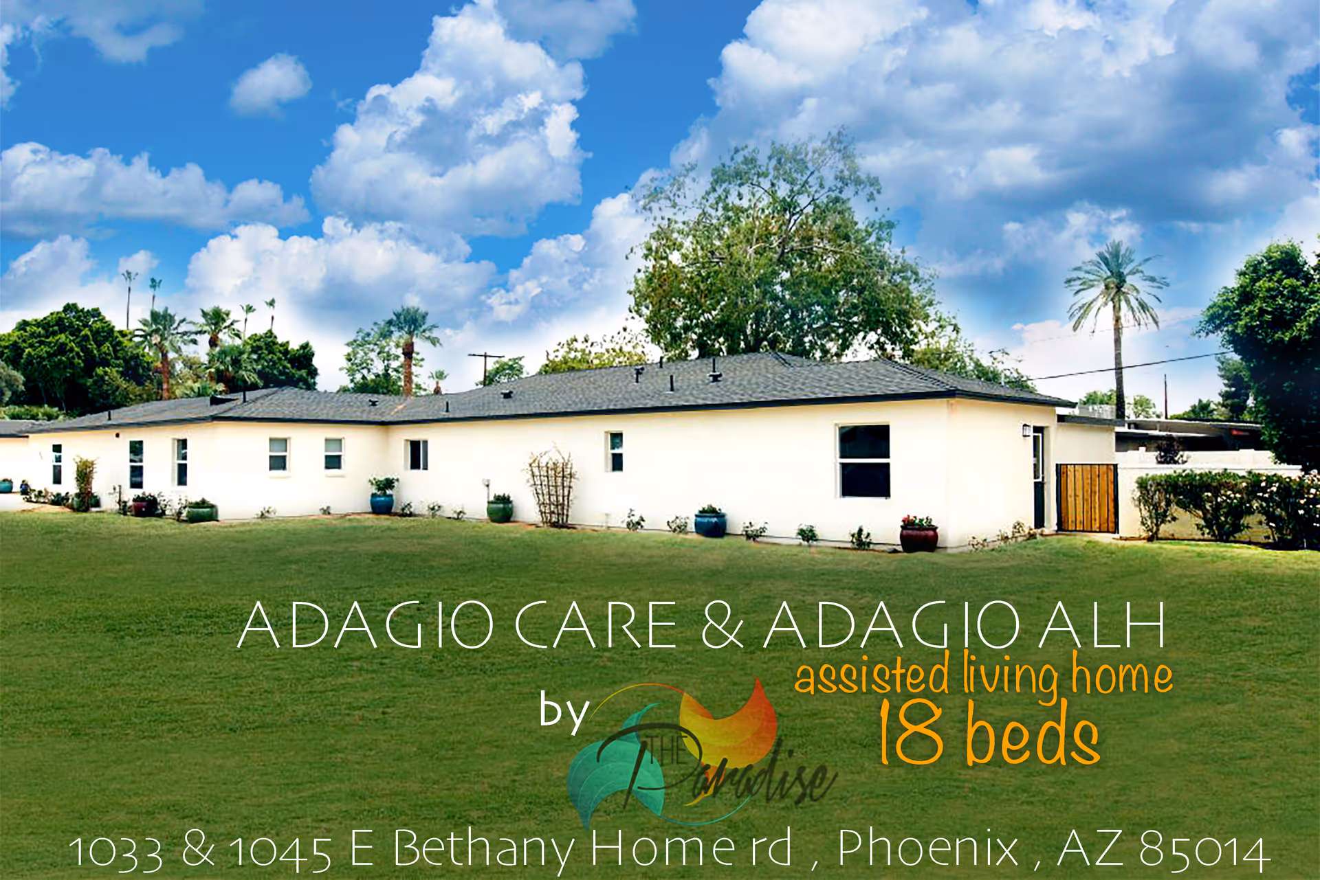 Single-story white senior living facility exterior with lawn, potted plants, and blue sky.