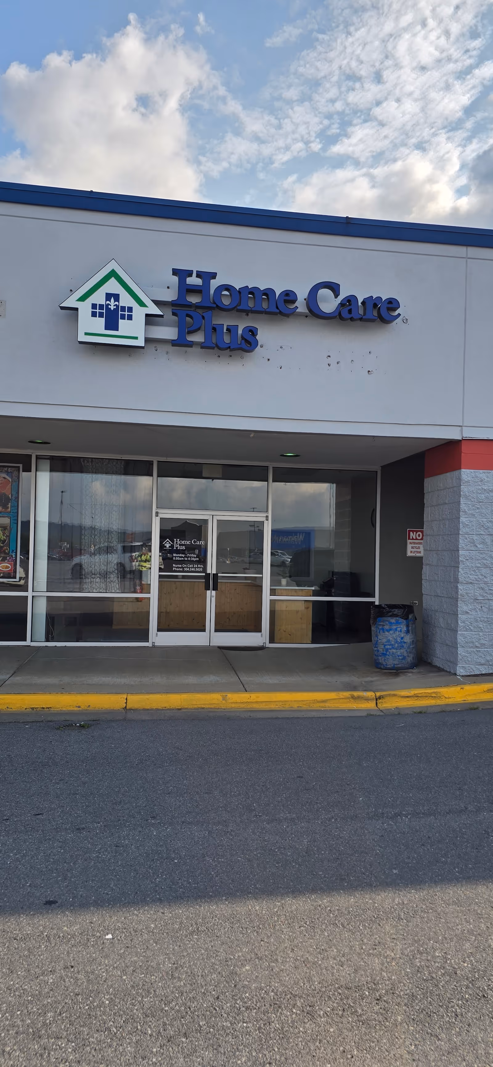 Exterior view of Home Care Plus storefront with glass doors and logo sign