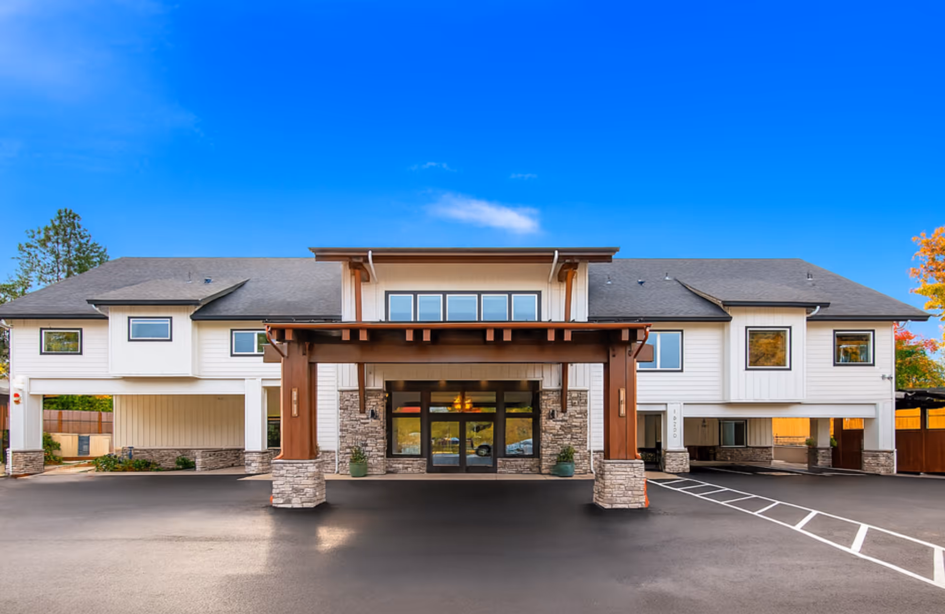 Front view of Serenity Hills Senior Living facility with covered entrance and stone pillars.