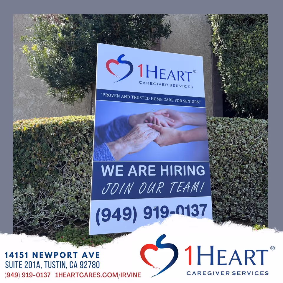 Outdoor sign for 1Heart Caregiver Services Irvine announcing hiring.