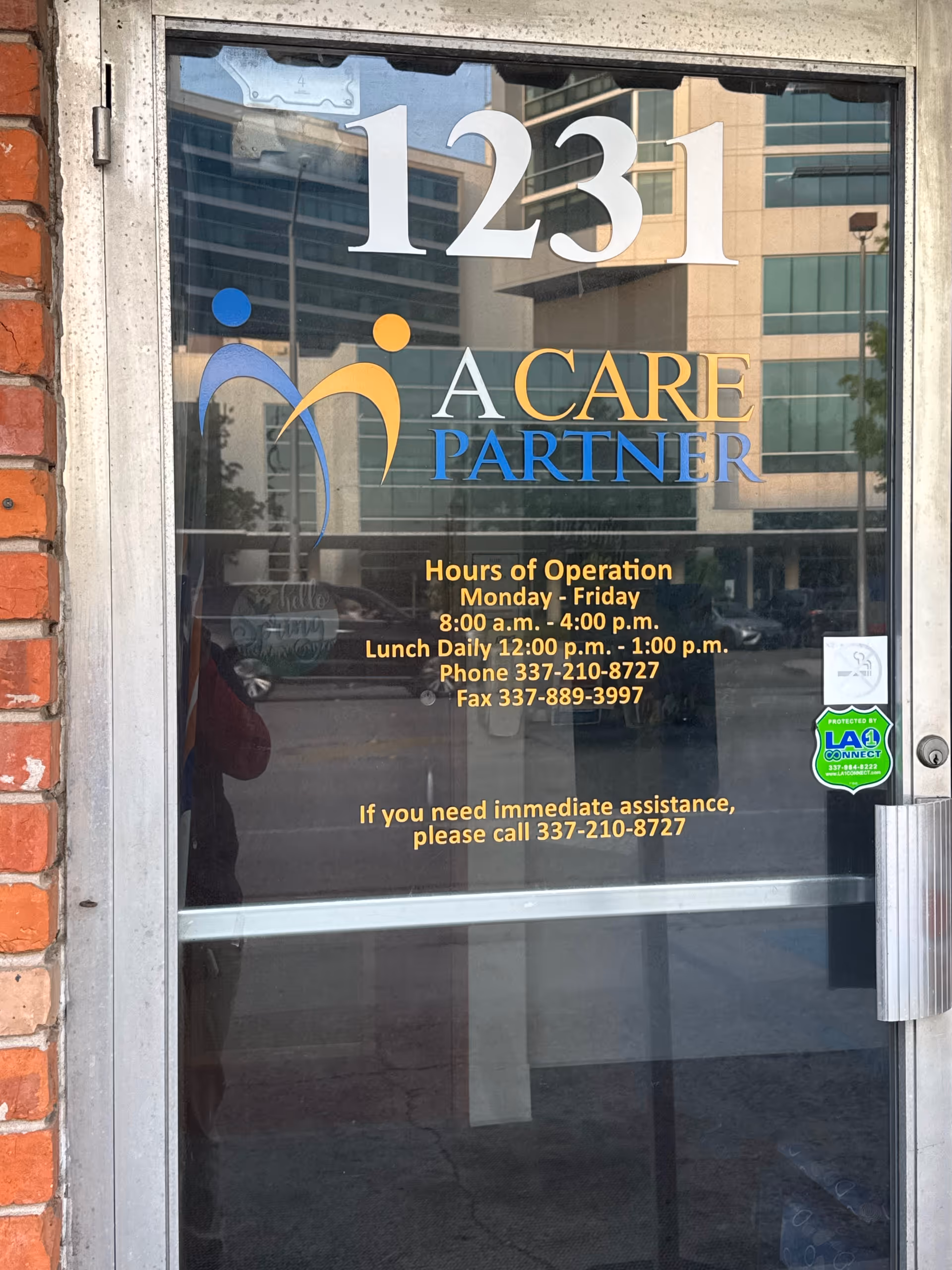 Glass door with A CARE PARTNER logo, 1231 address, and hours of operation