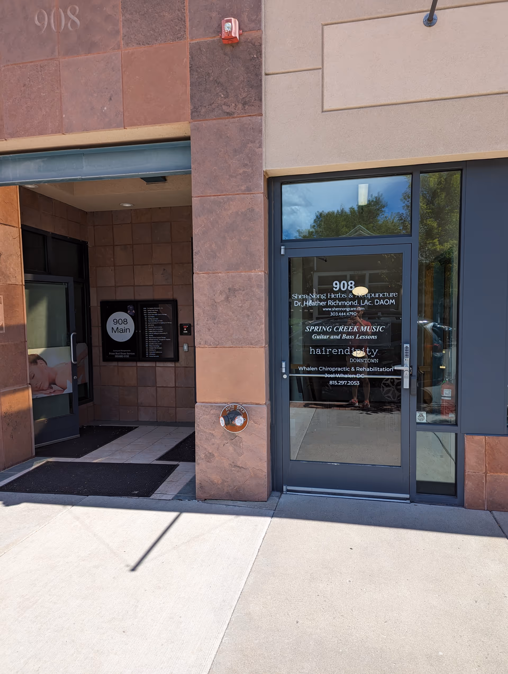 Entrance to Whalen Chiropractic and Rehabilitation building with glass door and address 908 Main.