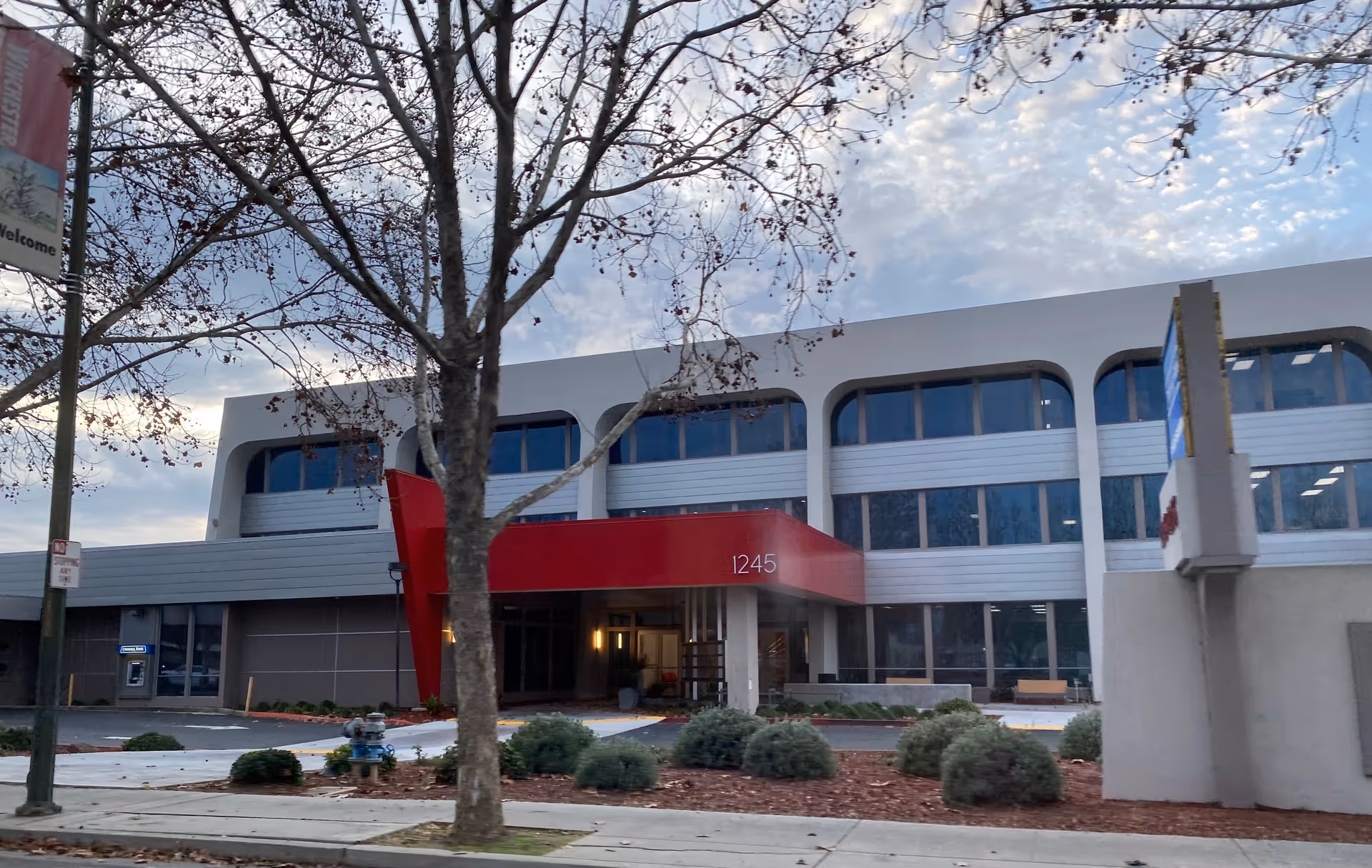 Exterior view of Focus Health San Jose building with red entrance canopy and landscaping.