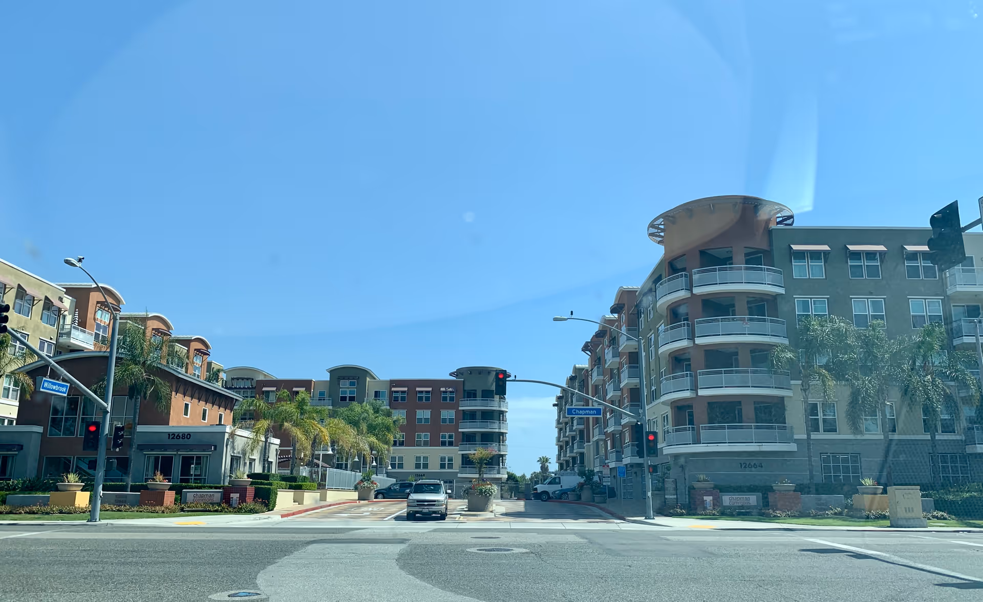Exterior view of Chapman Commons housing complex along a street with multi-story buildings.