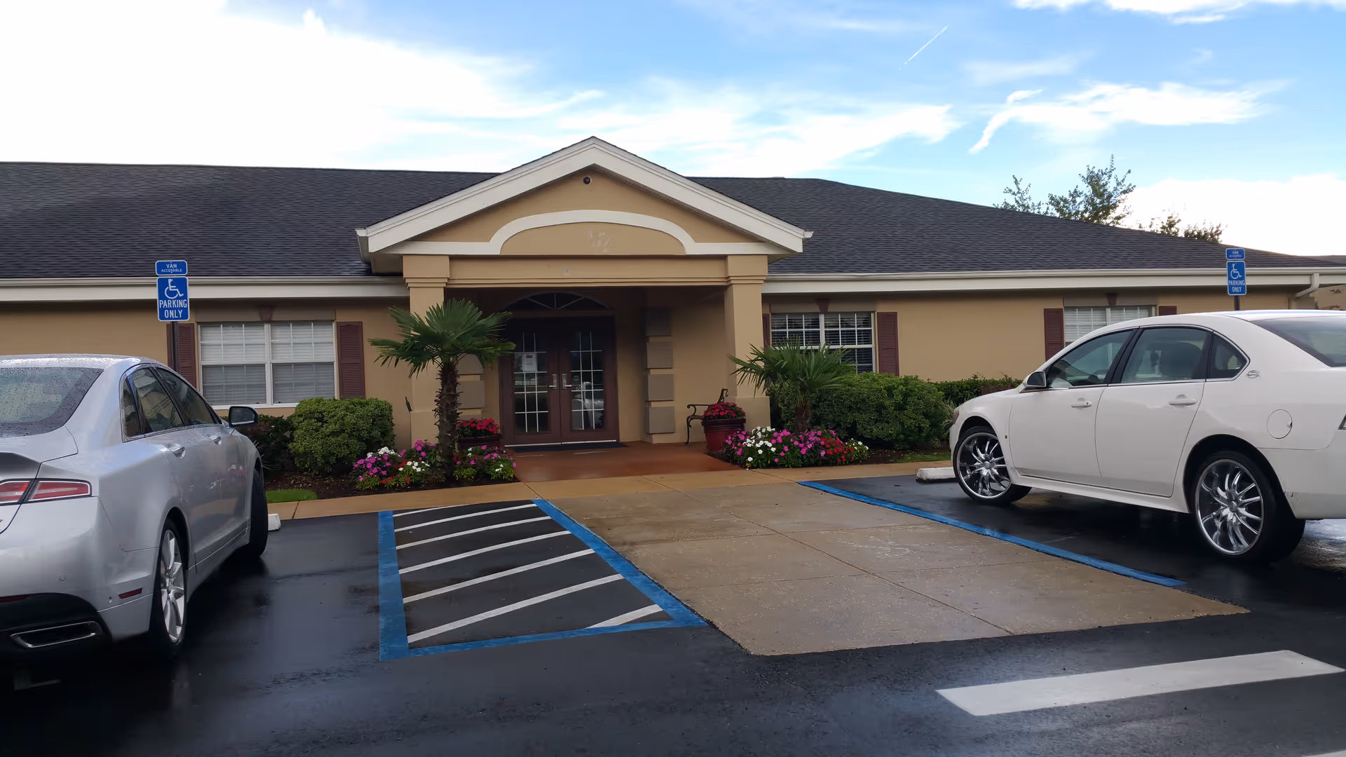 Exterior view of The Waterford at Creekside entrance with handicap parking and landscaping.