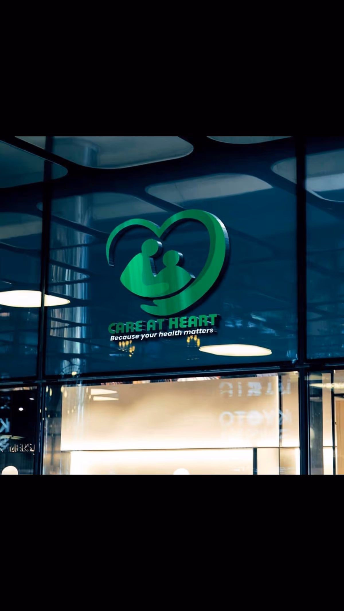 Exterior view of Care At Heart storefront logo on glass windows