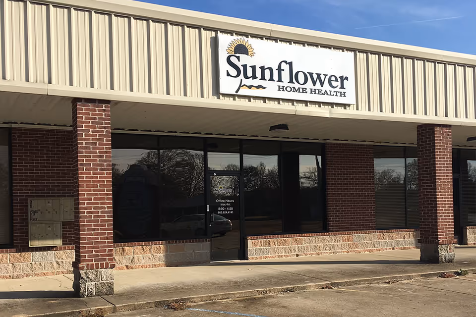 Sunflower Home Health storefront exterior with brick columns and a large sign.