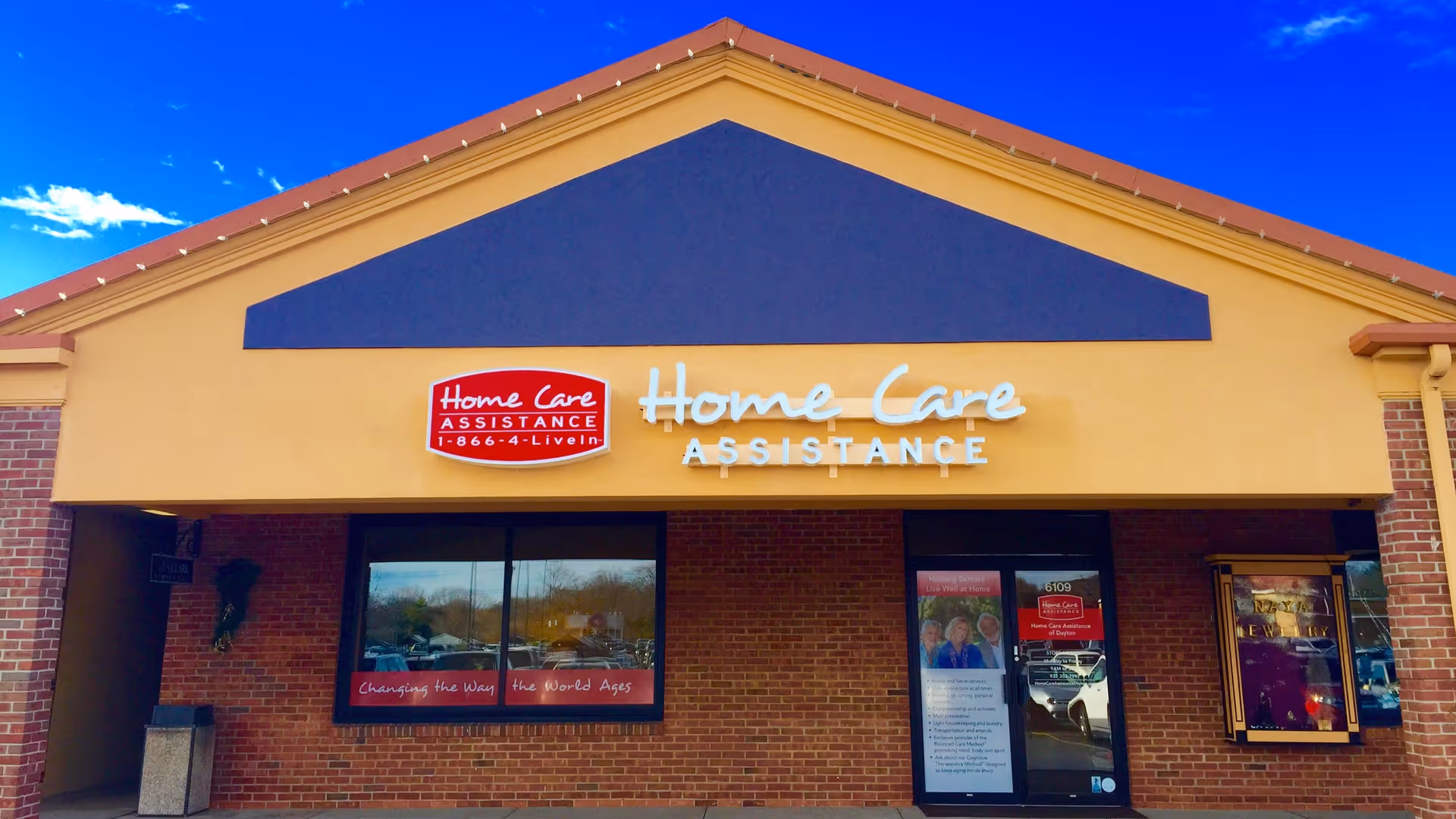 Front of Home Care Assistance storefront with brick facade and large sign.