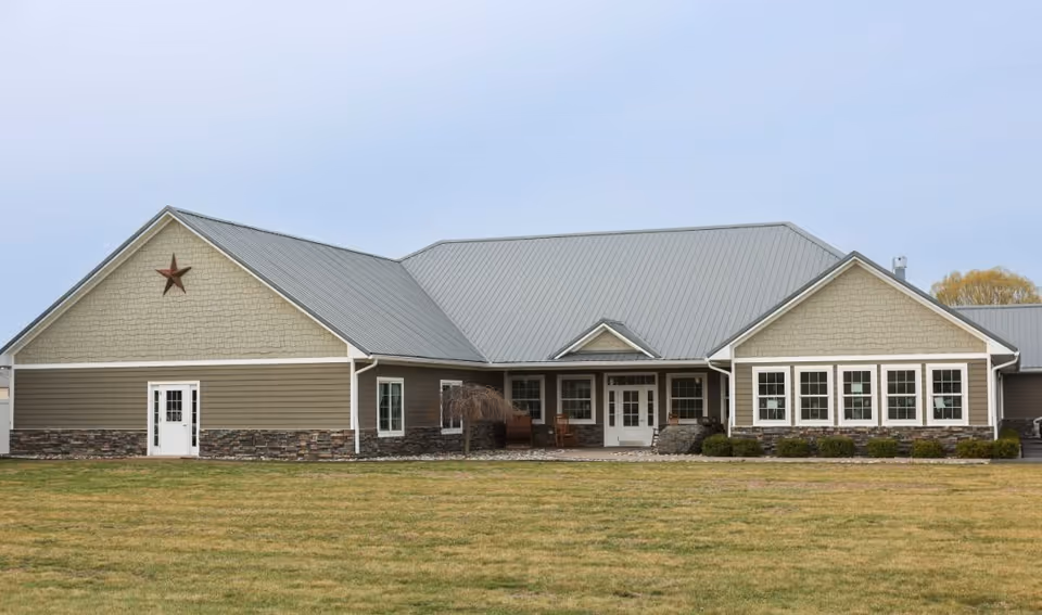Exterior view of Elder Ridge Manor II, a single-story facility with beige siding and stone accents.