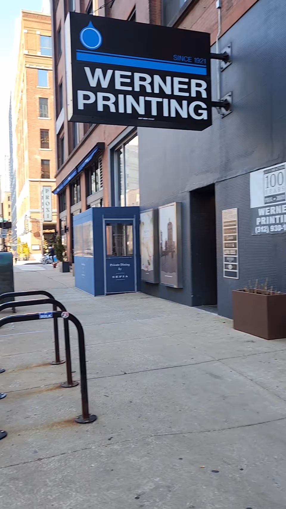 Street view of a building with a large Werner Printing sign overhead.