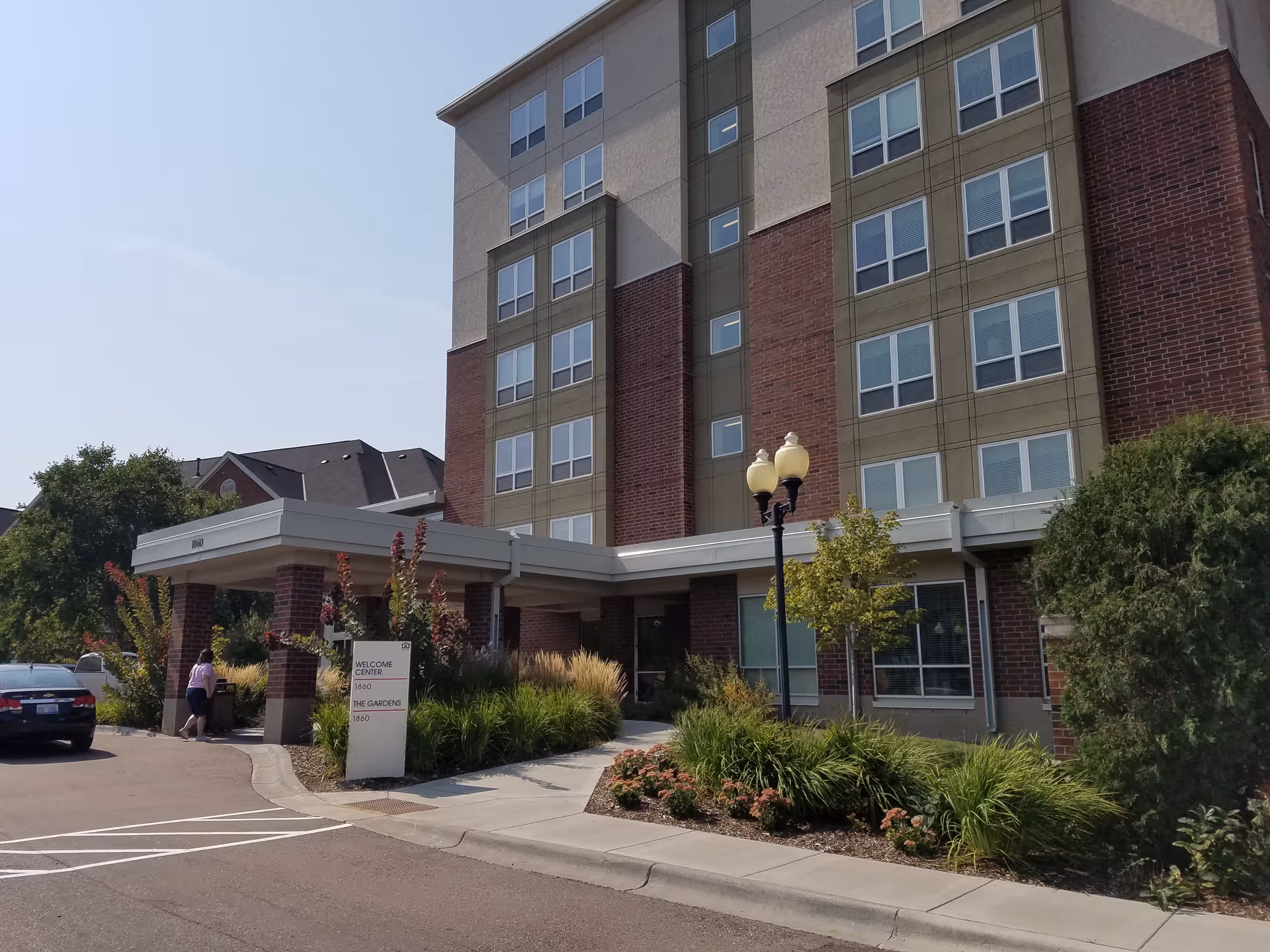 Exterior view of Episcopal Homes of Minnesota building with entrance canopy and landscaped grounds.