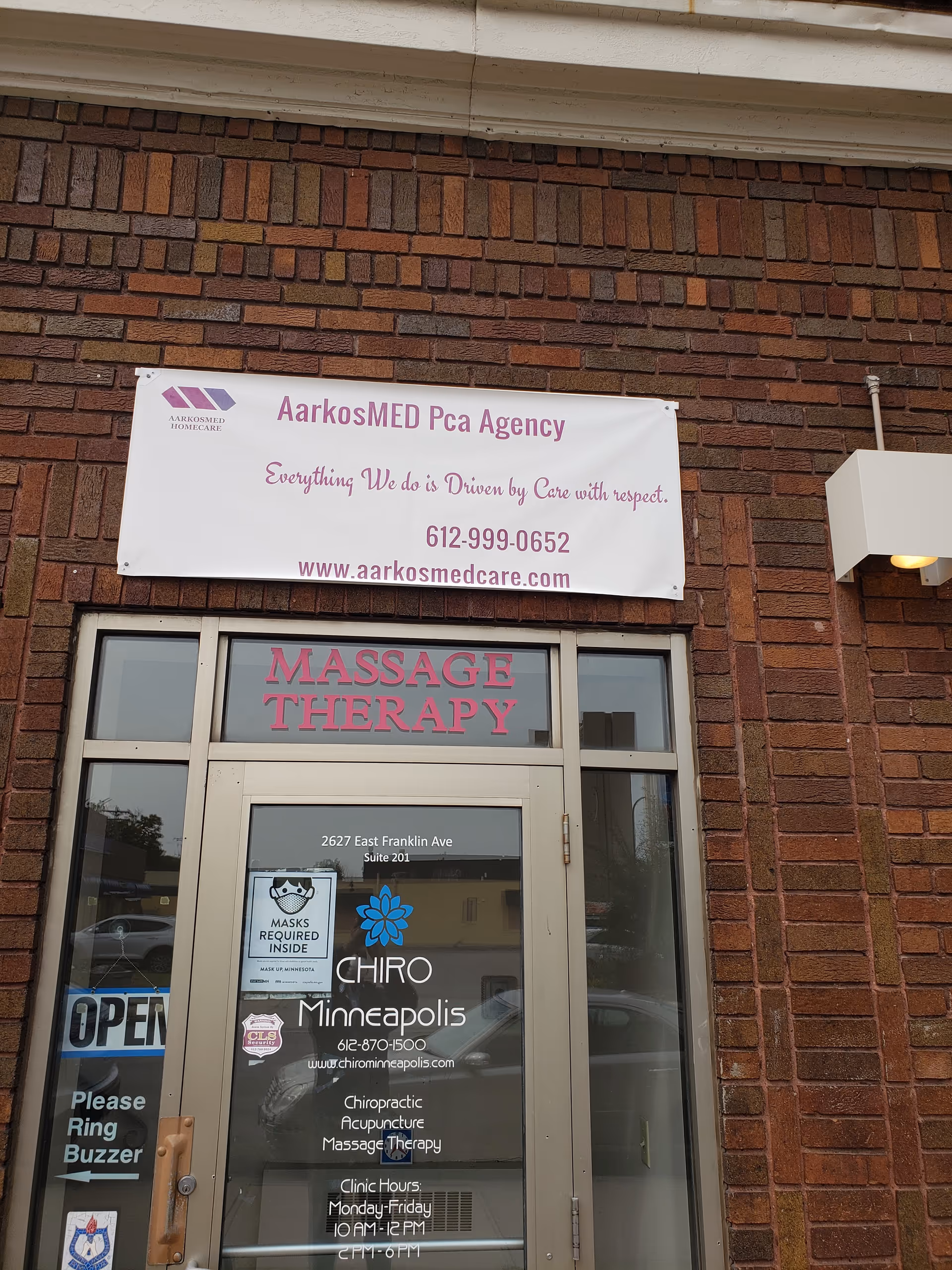 Brick building exterior with a white banner for AarkosMED Homecare.