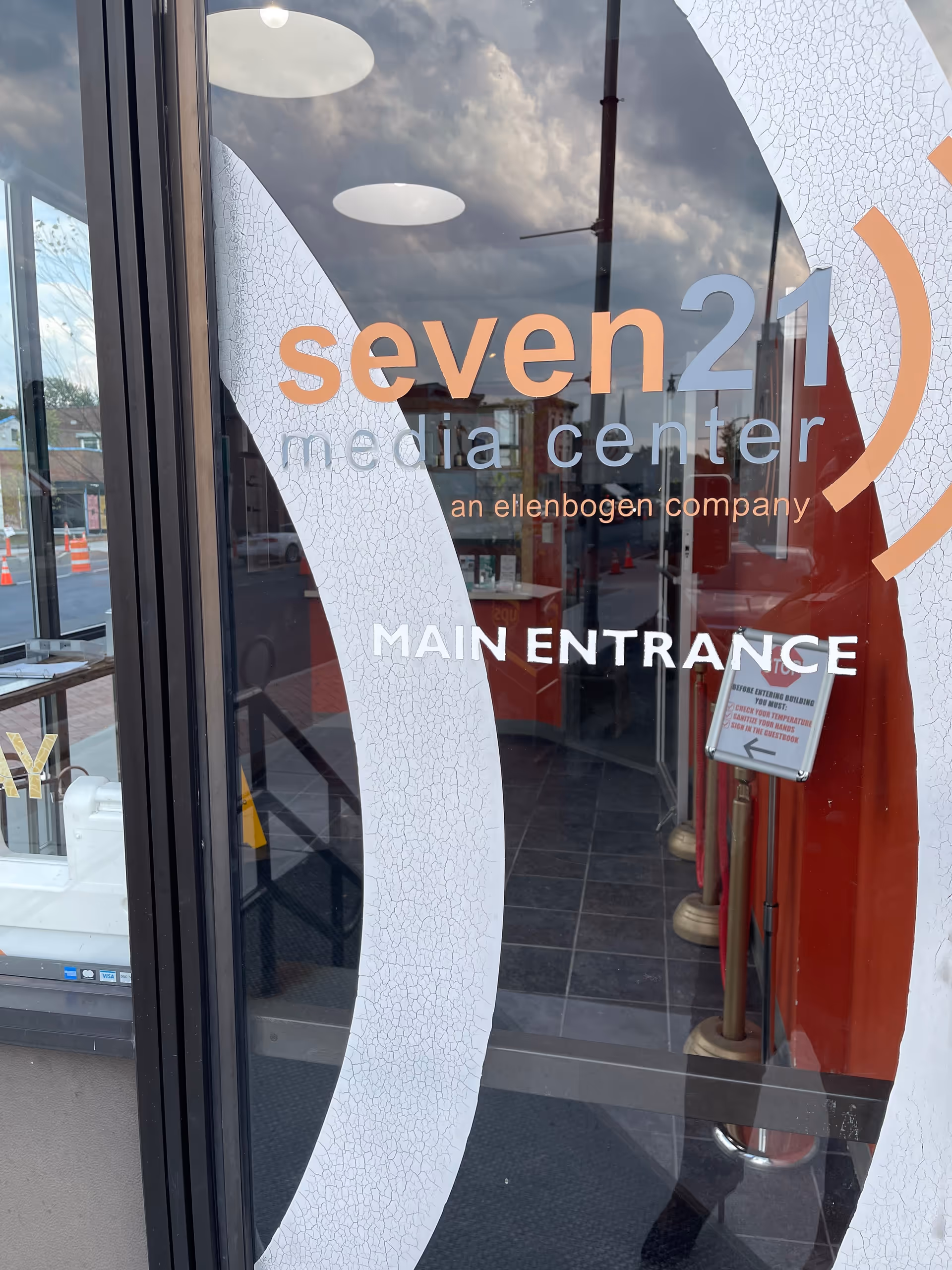 Glass entrance doors with seven21 media center branding and Main Entrance sign.